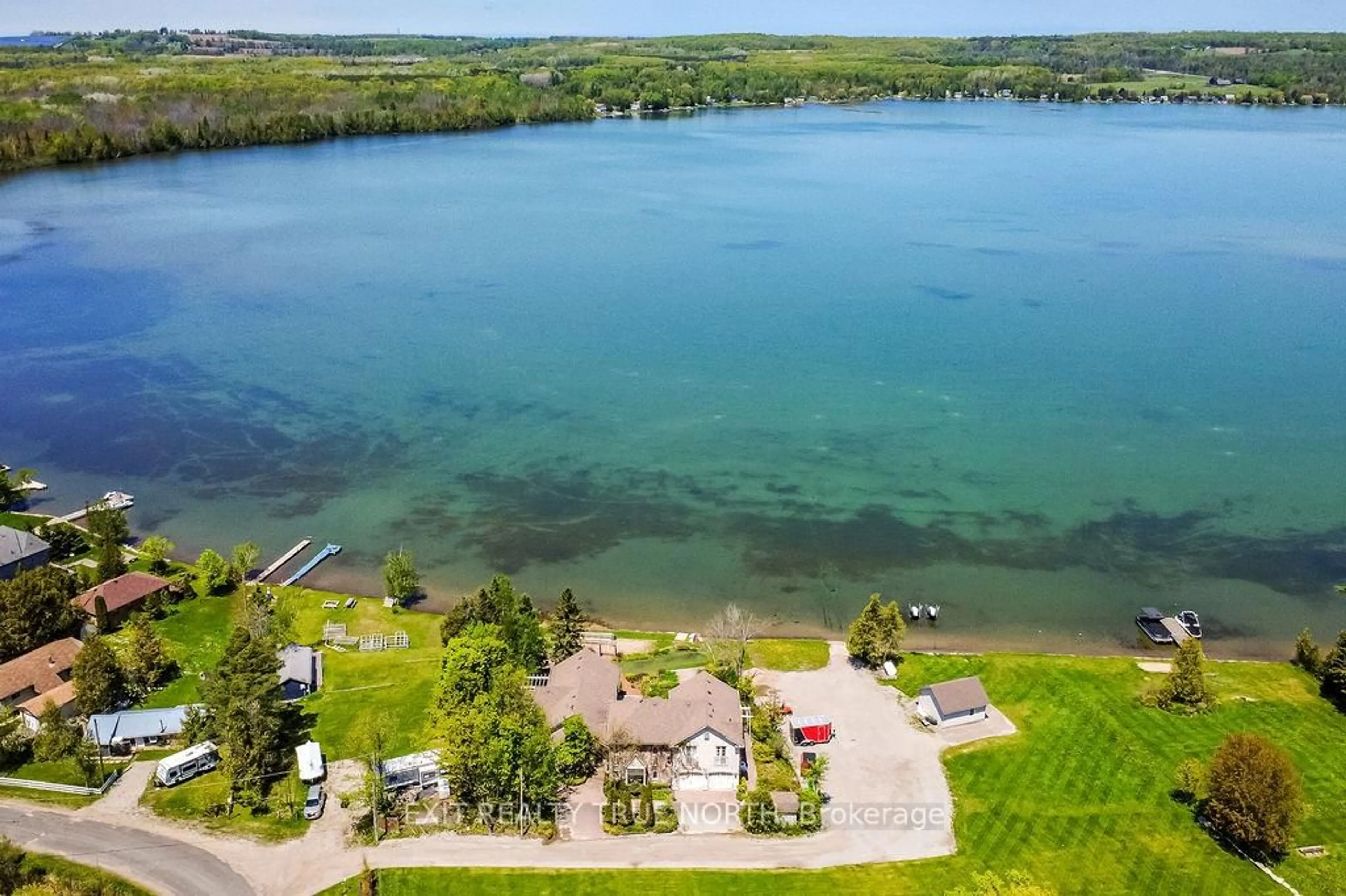 A pic from outside/outdoor area/front of a property/back of a property/a pic from drone, water/lake/river/ocean view for 3021 Sandy Bend, Springwater Ontario L0L 1P0