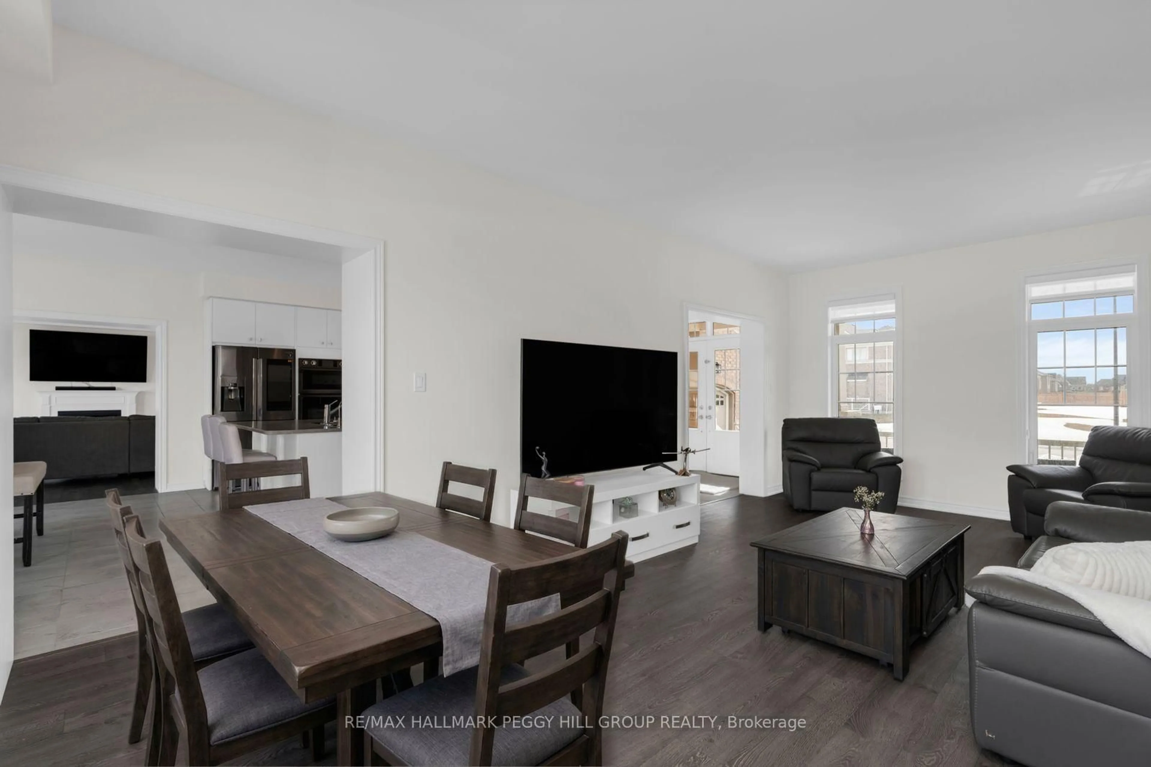 Living room with furniture, wood/laminate floor for 113 Rugman Cres, Springwater Ontario L9X 2A5