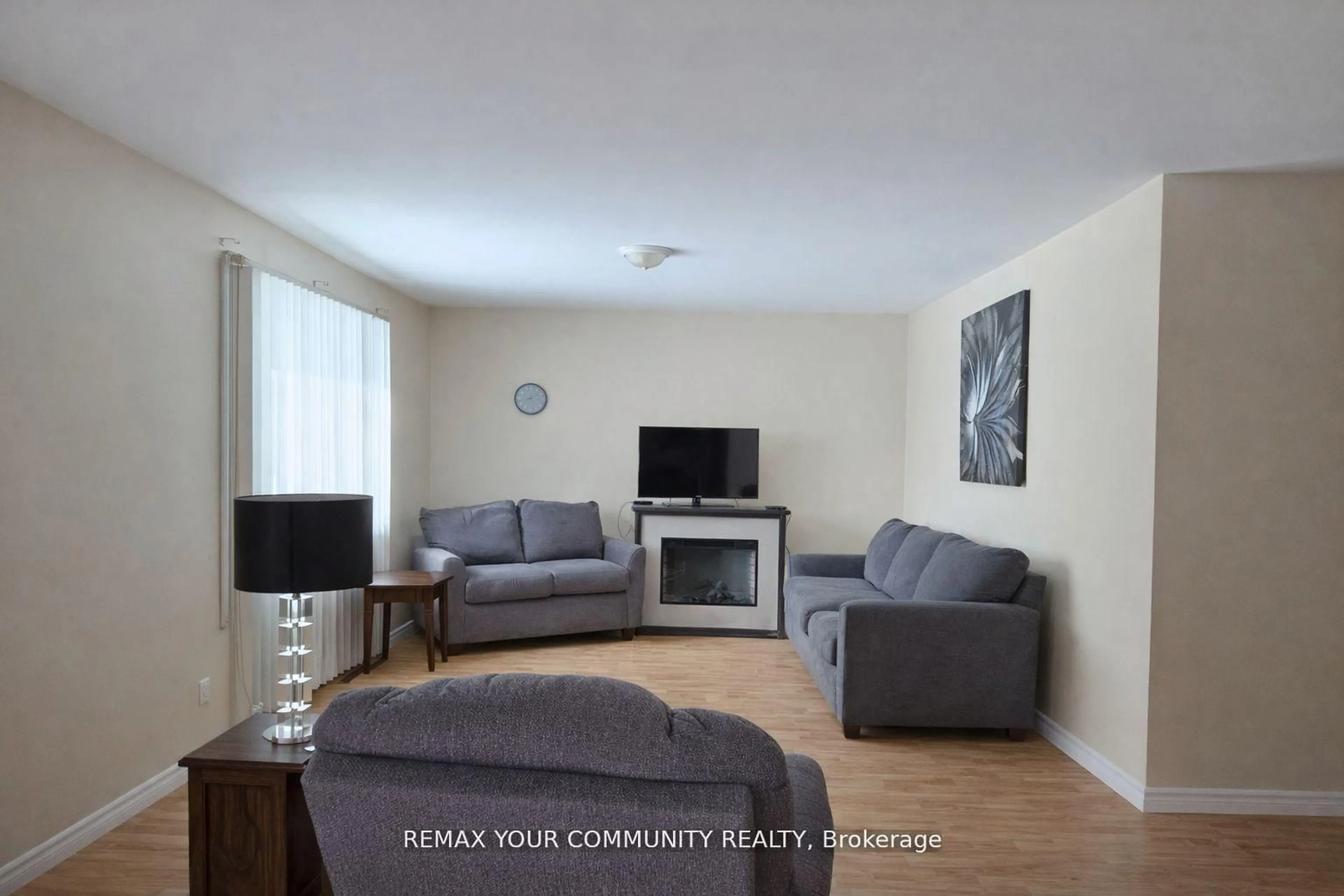 Living room with furniture, wood/laminate floor for 3414 Lee Ave, Severn Ontario L0K 1G0