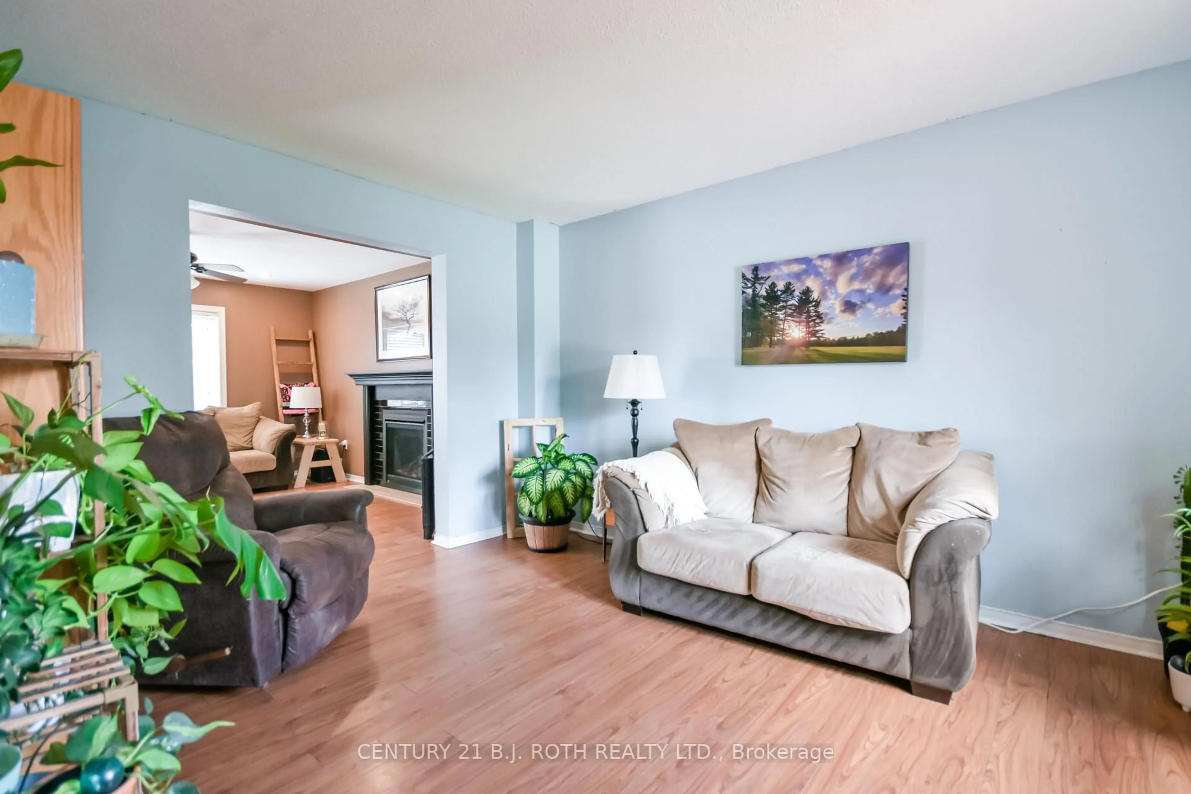 Living room with furniture, wood/laminate floor for 42 Farmstead Cres, Barrie Ontario L4N 8S1