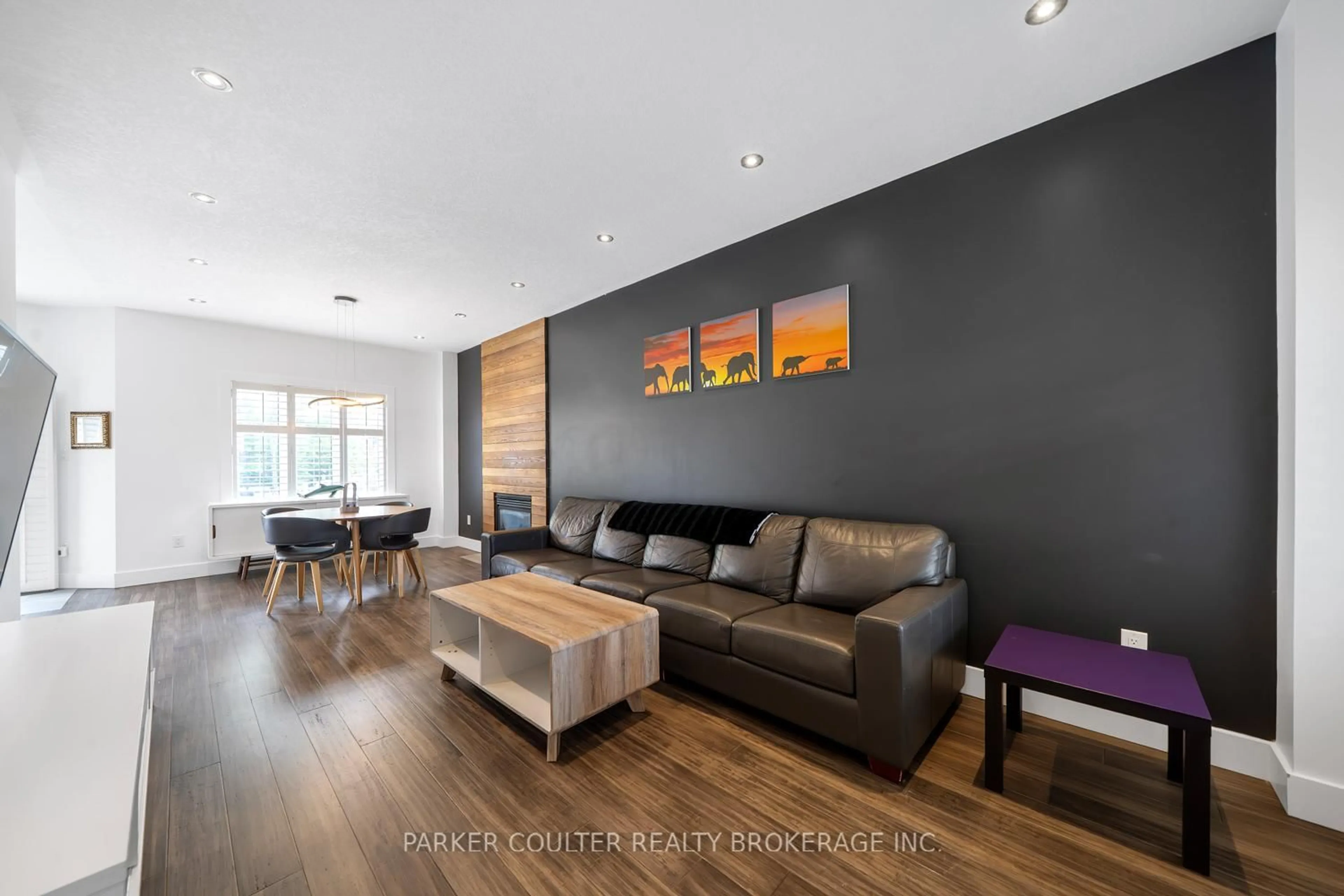 Living room with furniture, wood/laminate floor for 9 Surrey Dr, Barrie Ontario L4M 0C5