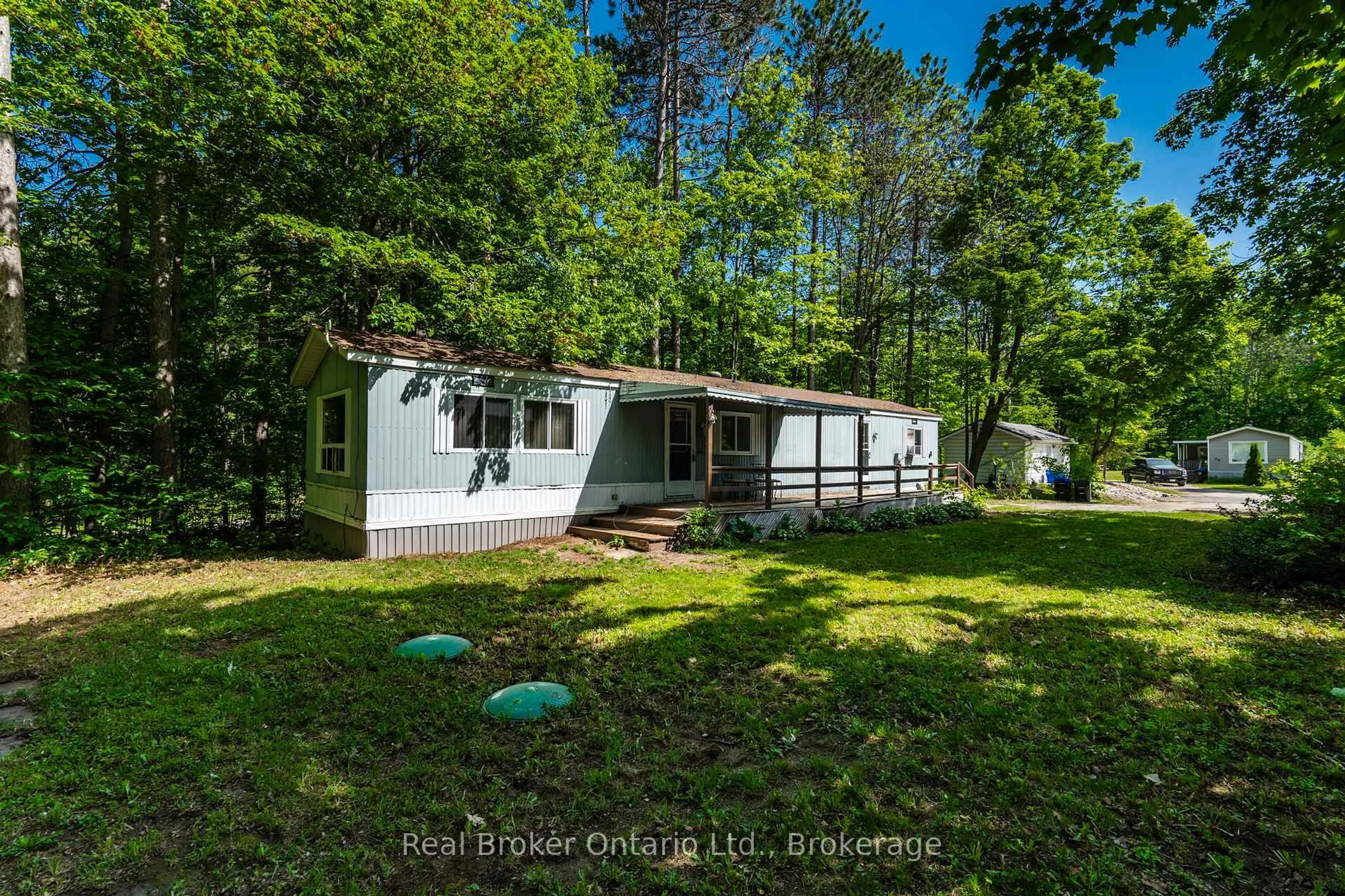 A pic from outside/outdoor area/front of a property/back of a property/a pic from drone, forest/trees view for 5263 Elliott Sdrd #48, Tay Ontario L4R 4K3