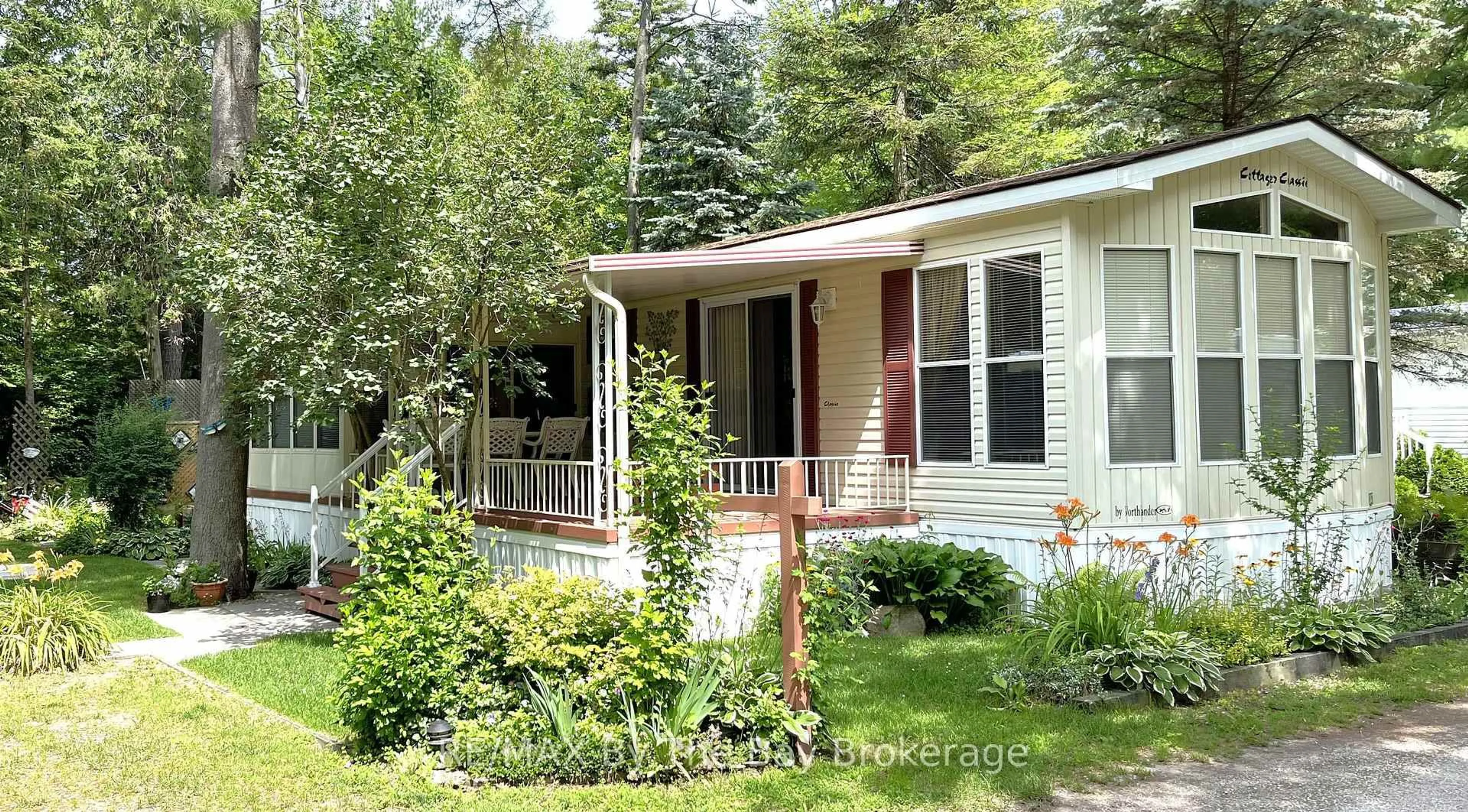 Home with vinyl exterior material, street for 85 Theme Park Dr #247, Wasaga Beach Ontario L9Z 1X7