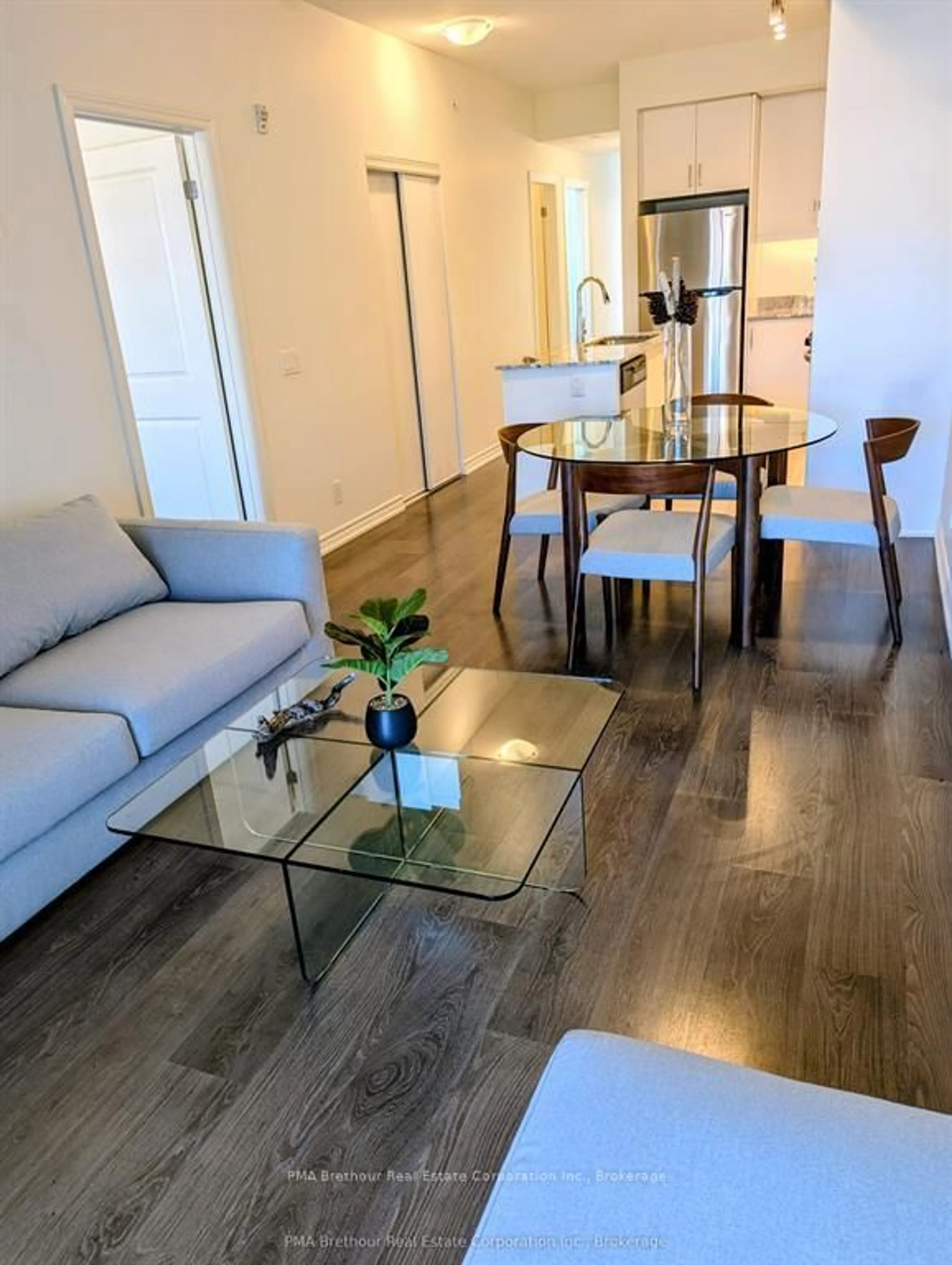 Living room with furniture, wood/laminate floor for 17 Spooner Cres #107, Collingwood Ontario L9Y 1T3