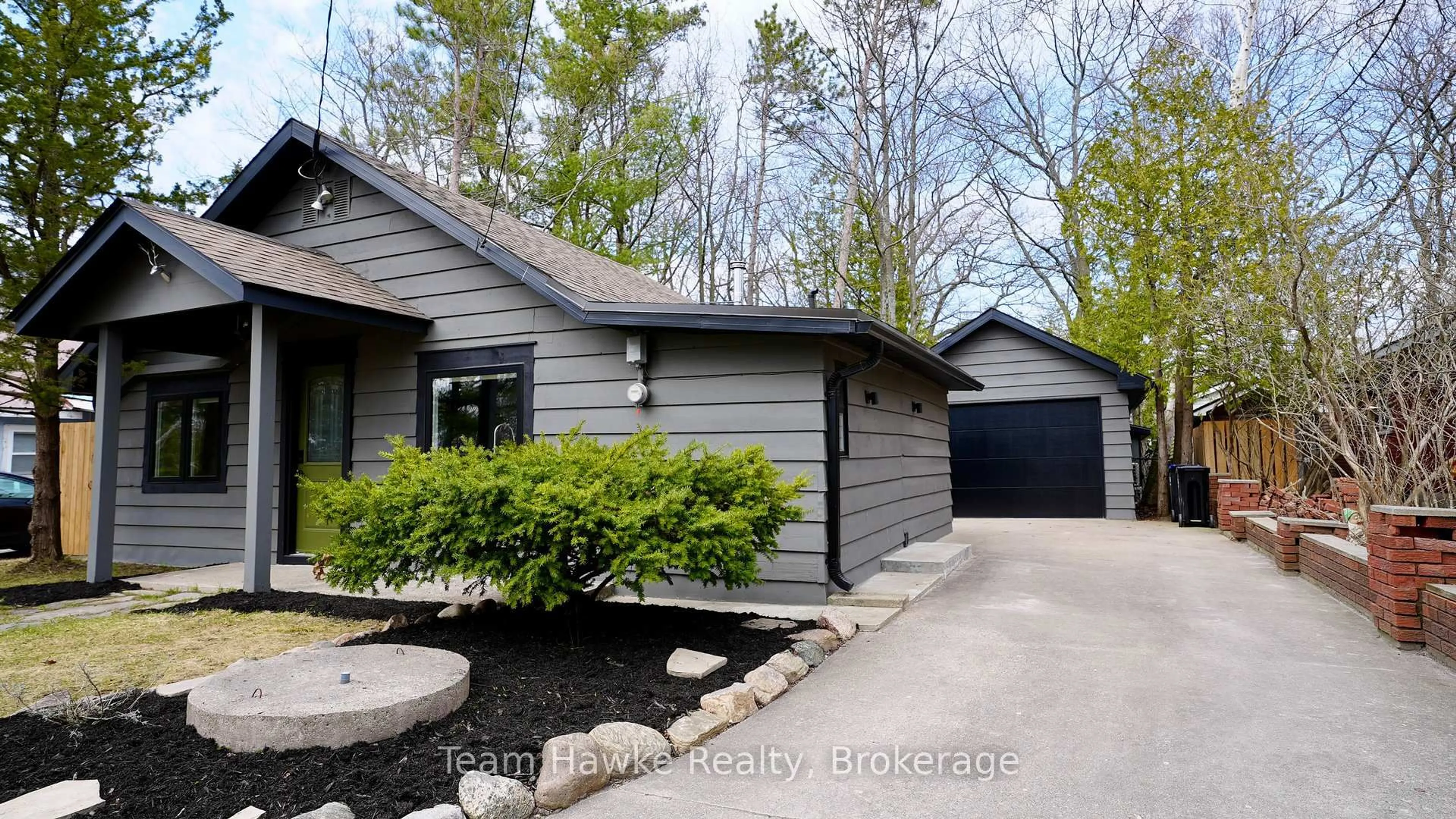 Home with vinyl exterior material, street for 283 Tiny Beaches Rd, Tiny Ontario L0L 2J0