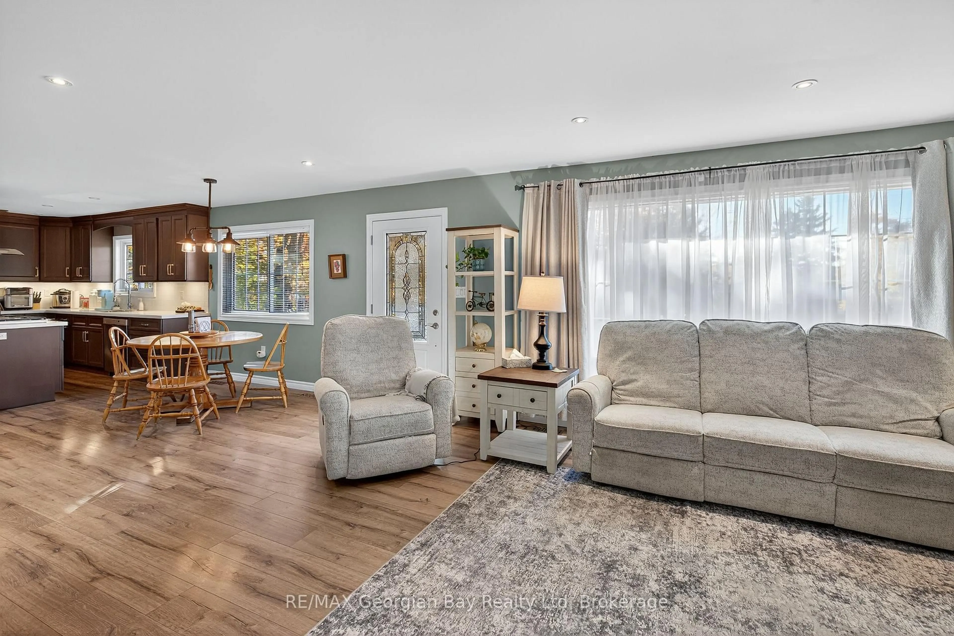 Living room with furniture, wood/laminate floor for 1034 Pine Grove Rd, Penetanguishene Ontario L9M 2B5