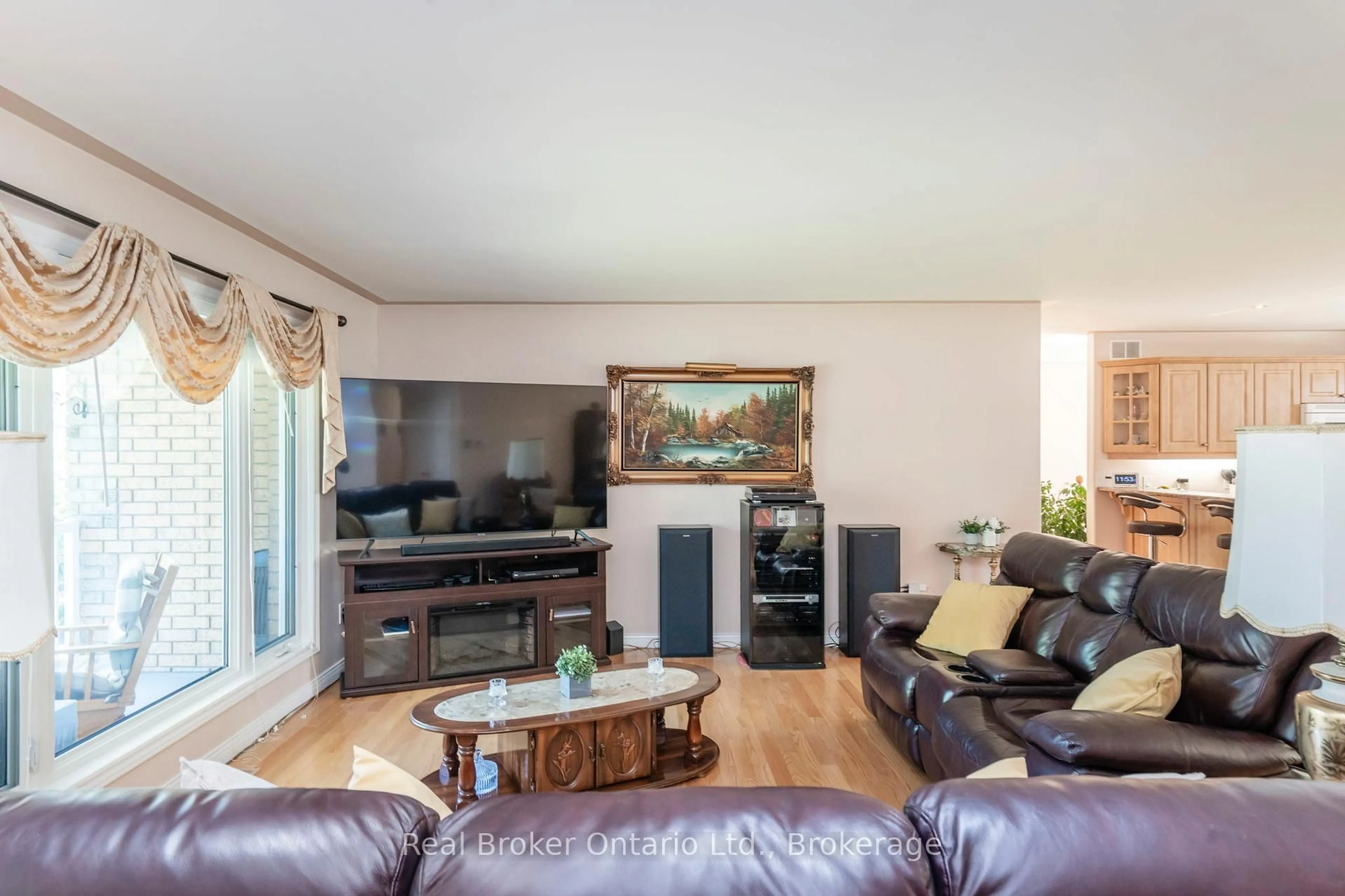 Living room with furniture, wood/laminate floor for 115 Mitchell's Beach Rd, Tay Ontario L0K 2A0