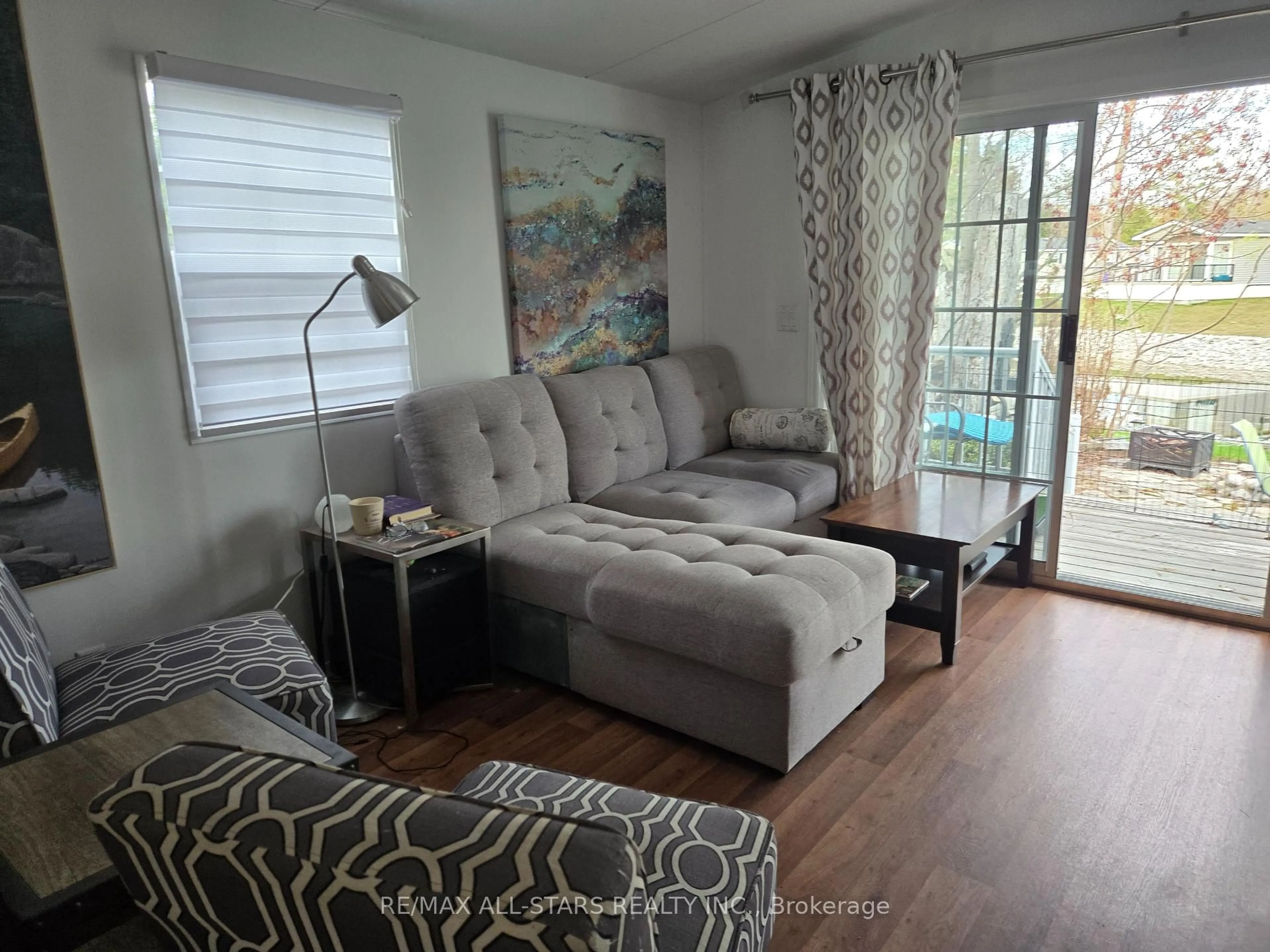 Living room with furniture, wood/laminate floor for 1 KENORA Tr, Wasaga Beach Ontario L9Z 1X7
