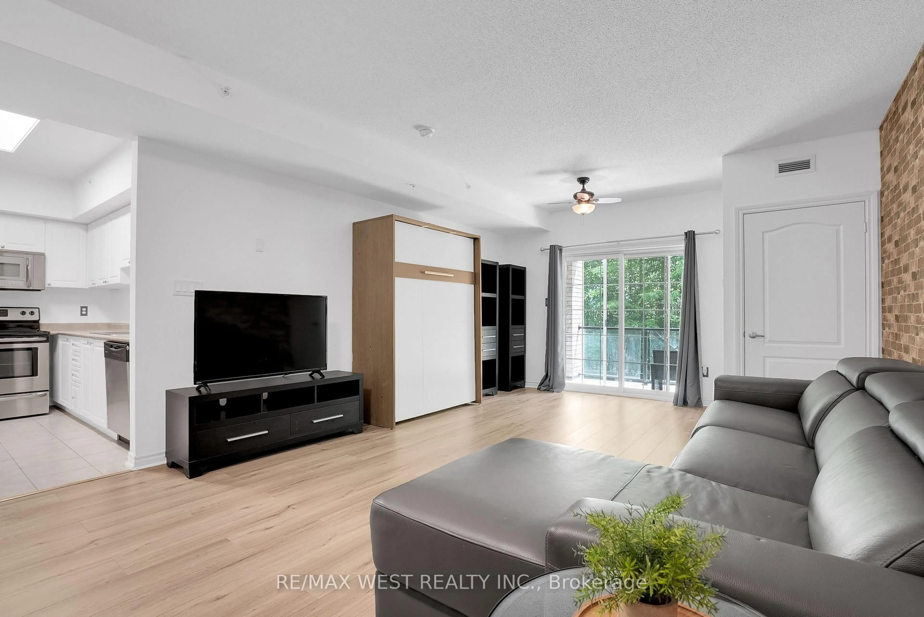 Living room with furniture, wood/laminate floor for 41 Ferndale Dr #110, Barrie Ontario L4N 5T6