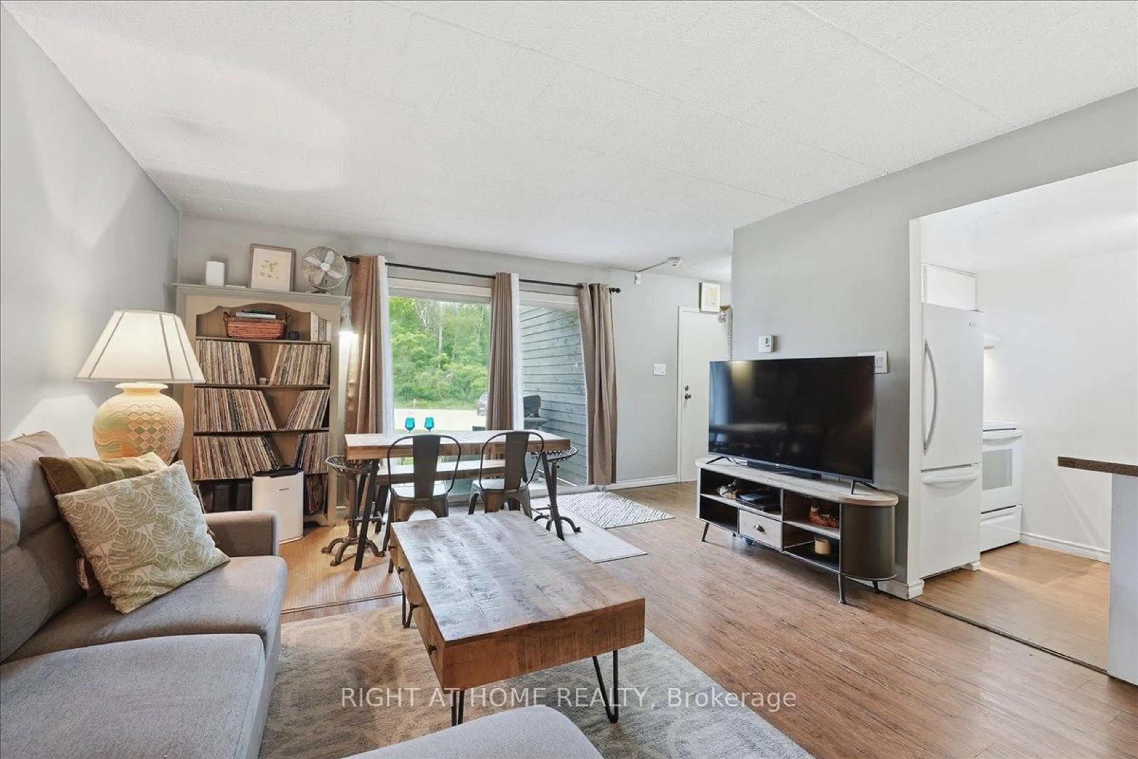 Living room with furniture, wood/laminate floor for 1102 Horseshoe Valley Rd #108, Oro-Medonte Ontario L4M 4Y8