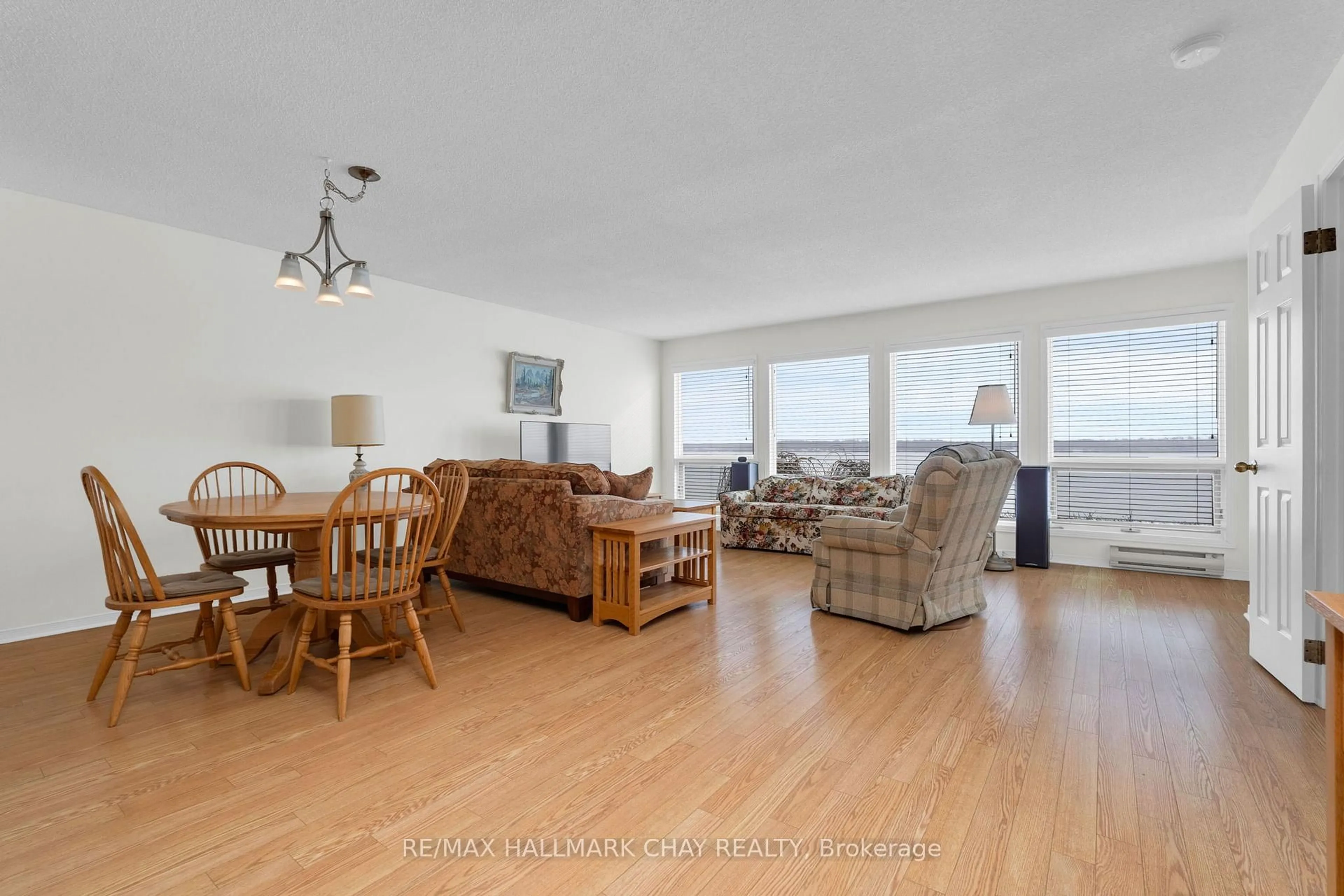 Living room with furniture, wood/laminate floor for 21 Kempenfelt Dr #103, Barrie Ontario L4M 1B8
