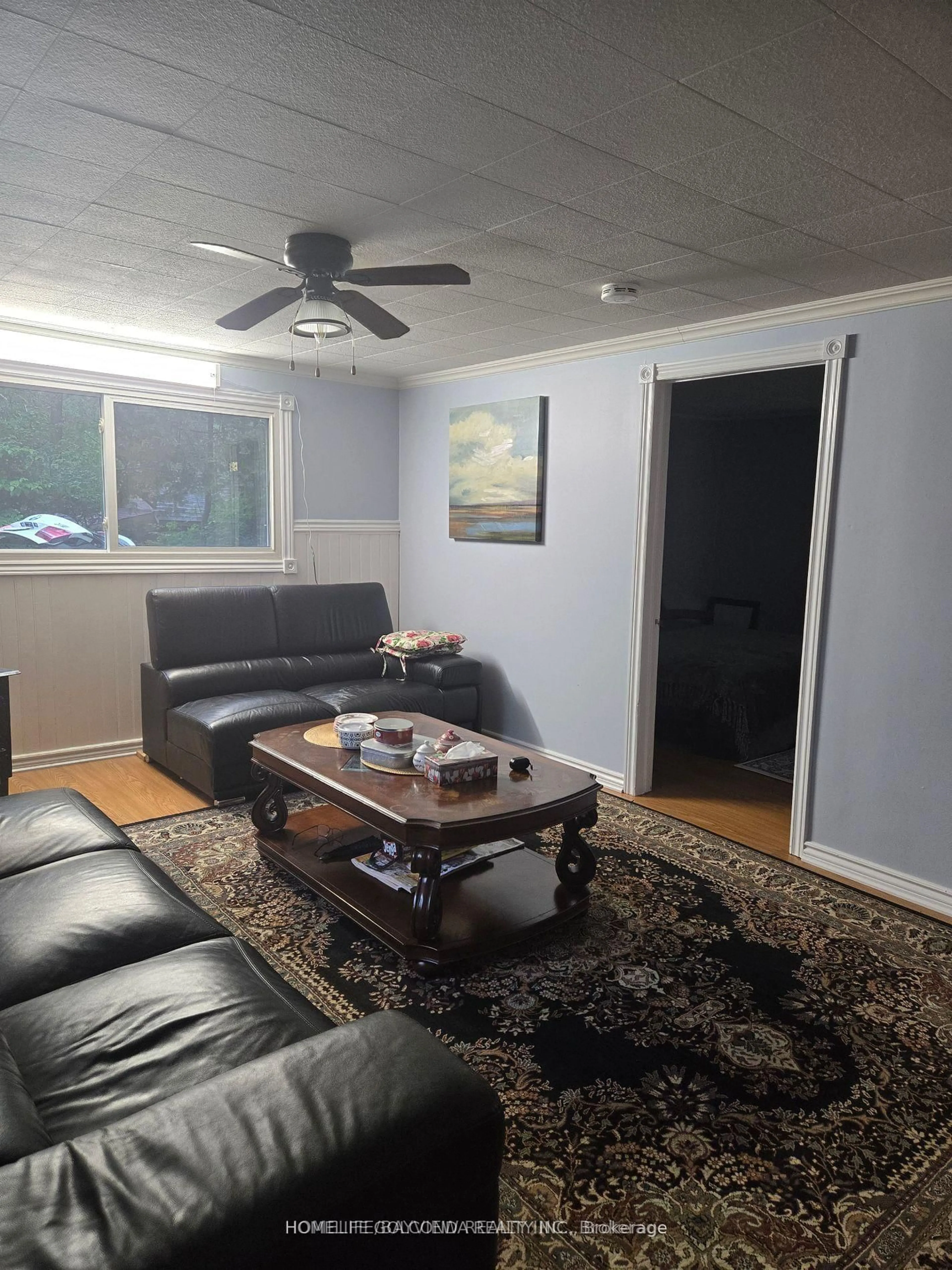 Living room with furniture, wood/laminate floor for 15 Poplar Cres, Oro-Medonte Ontario L0L 1T0