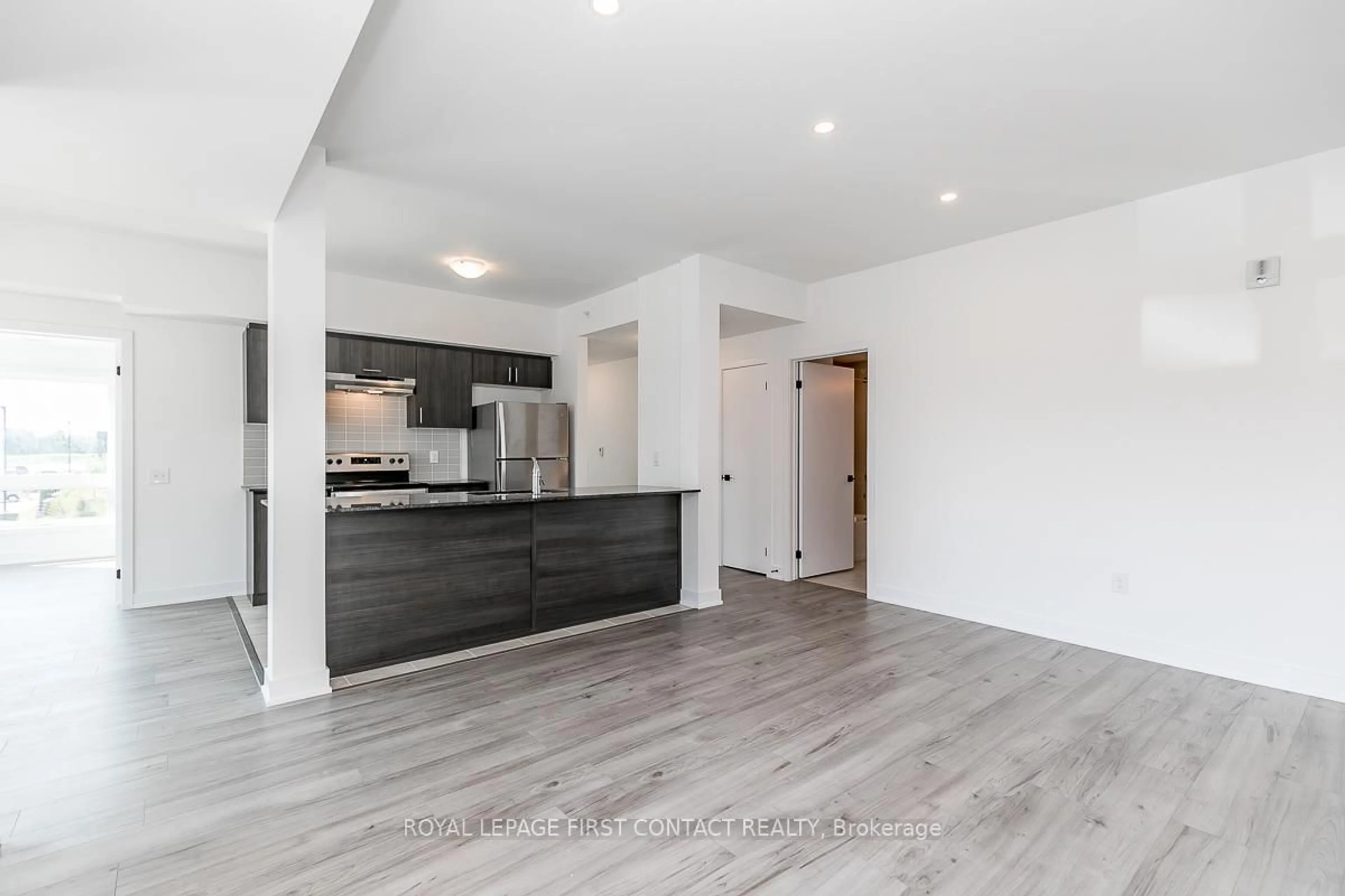 Open concept kitchen, wood/laminate floor for 8 Culinary Lane #101, Barrie Ontario L9J 0J9