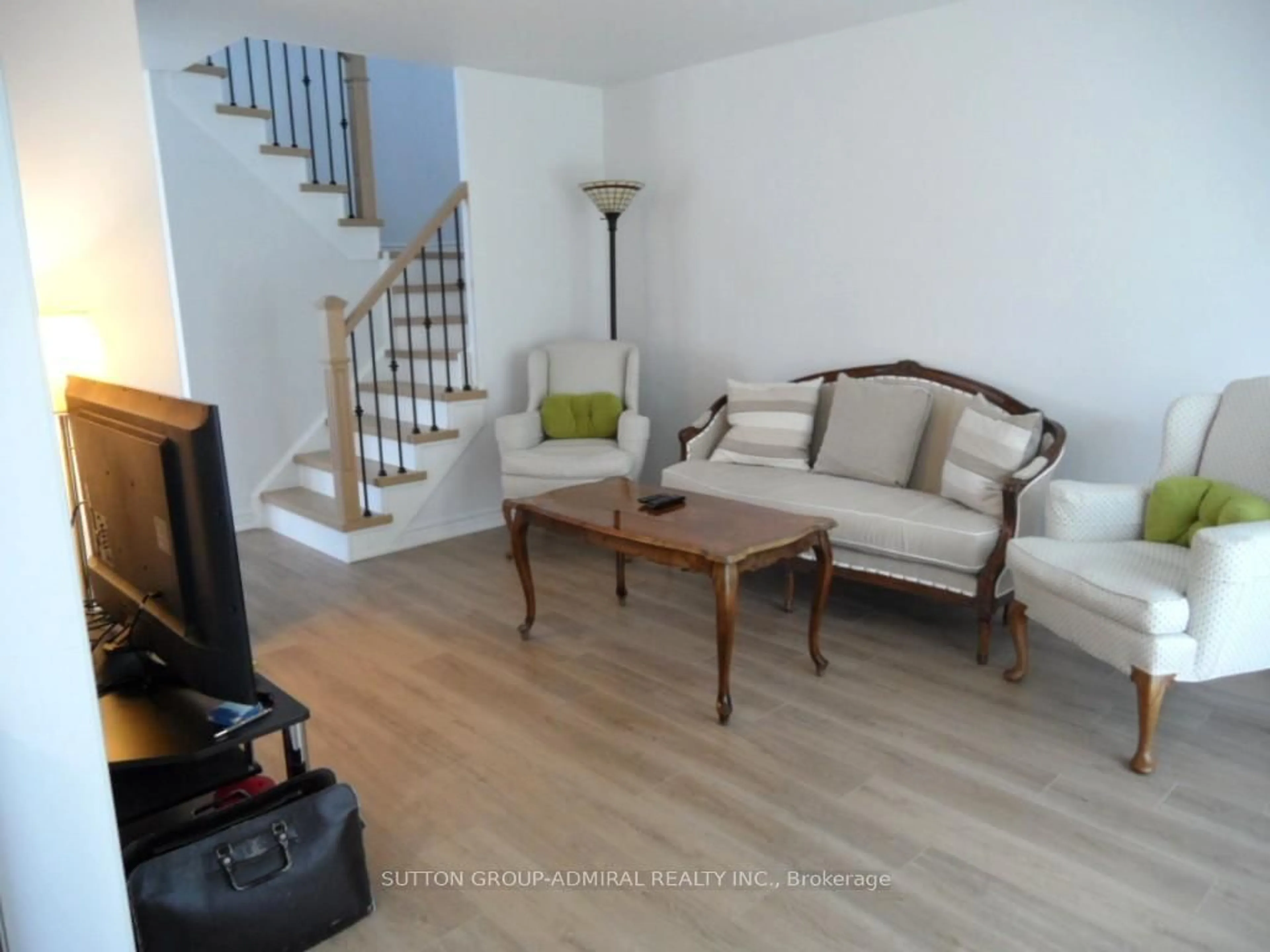 Living room with furniture, wood/laminate floor for 65 Delaney Cres, Barrie Ontario L4N 7C4