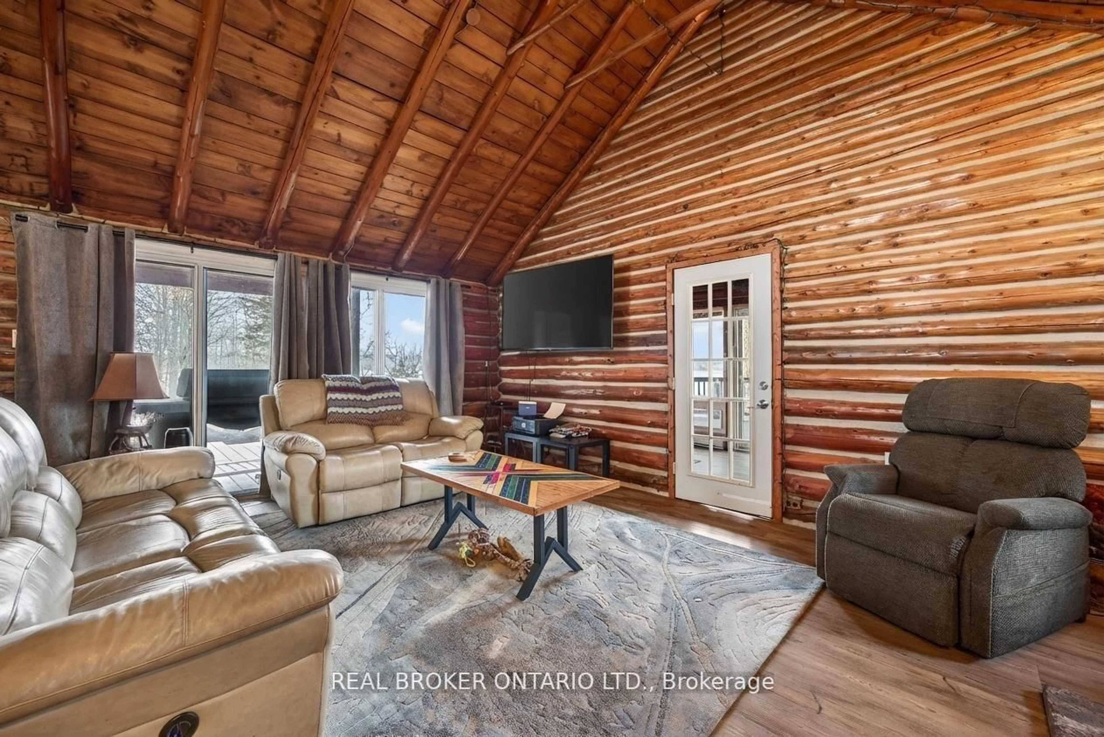Living room with furniture, wood/laminate floor for 1866 Tay Bay Rd, Severn Ontario L0K 1E0