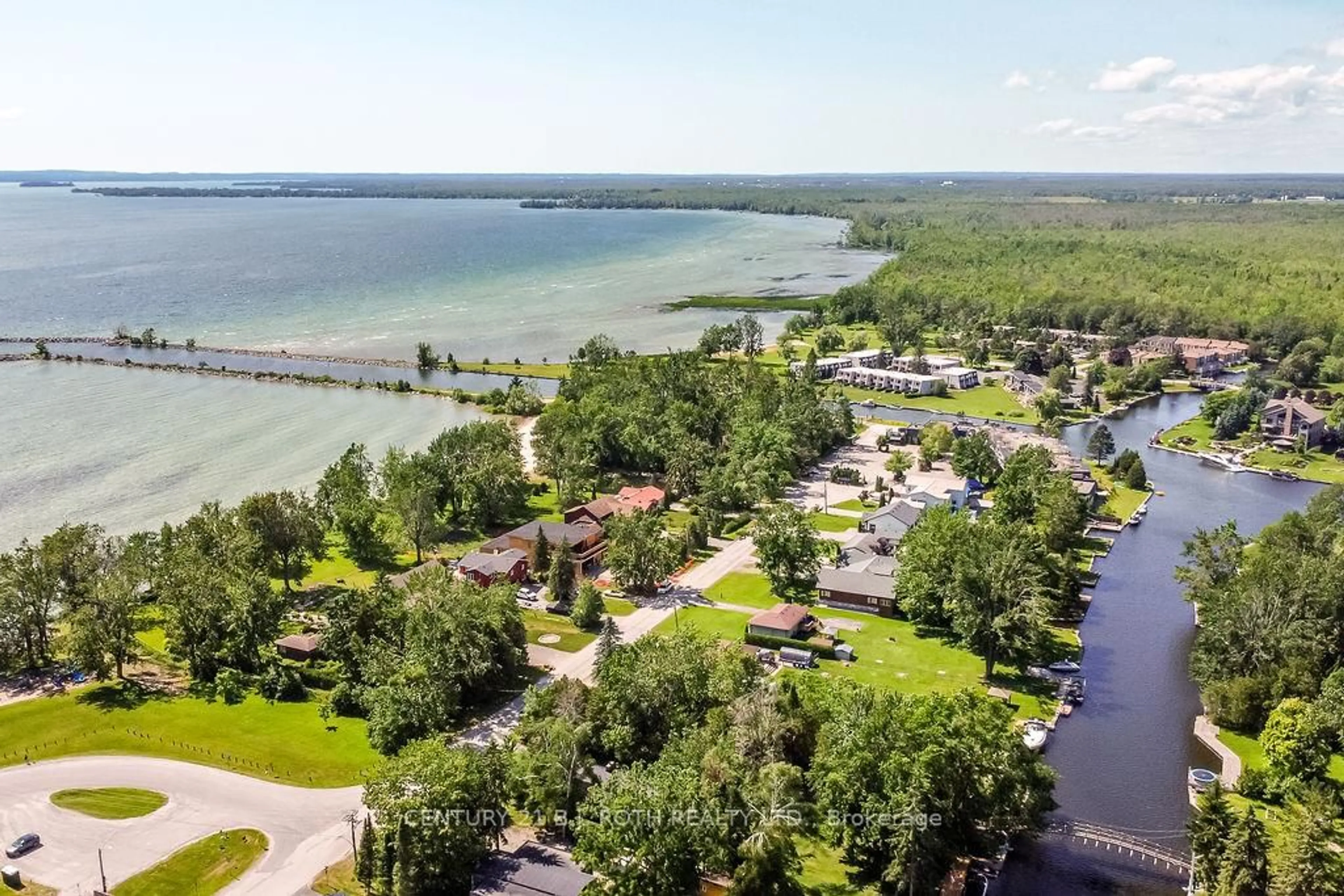 A pic from outside/outdoor area/front of a property/back of a property/a pic from drone, water/lake/river/ocean view for 1 Paradise Blvd #Unit 14, Ramara Ontario L0K 1B0