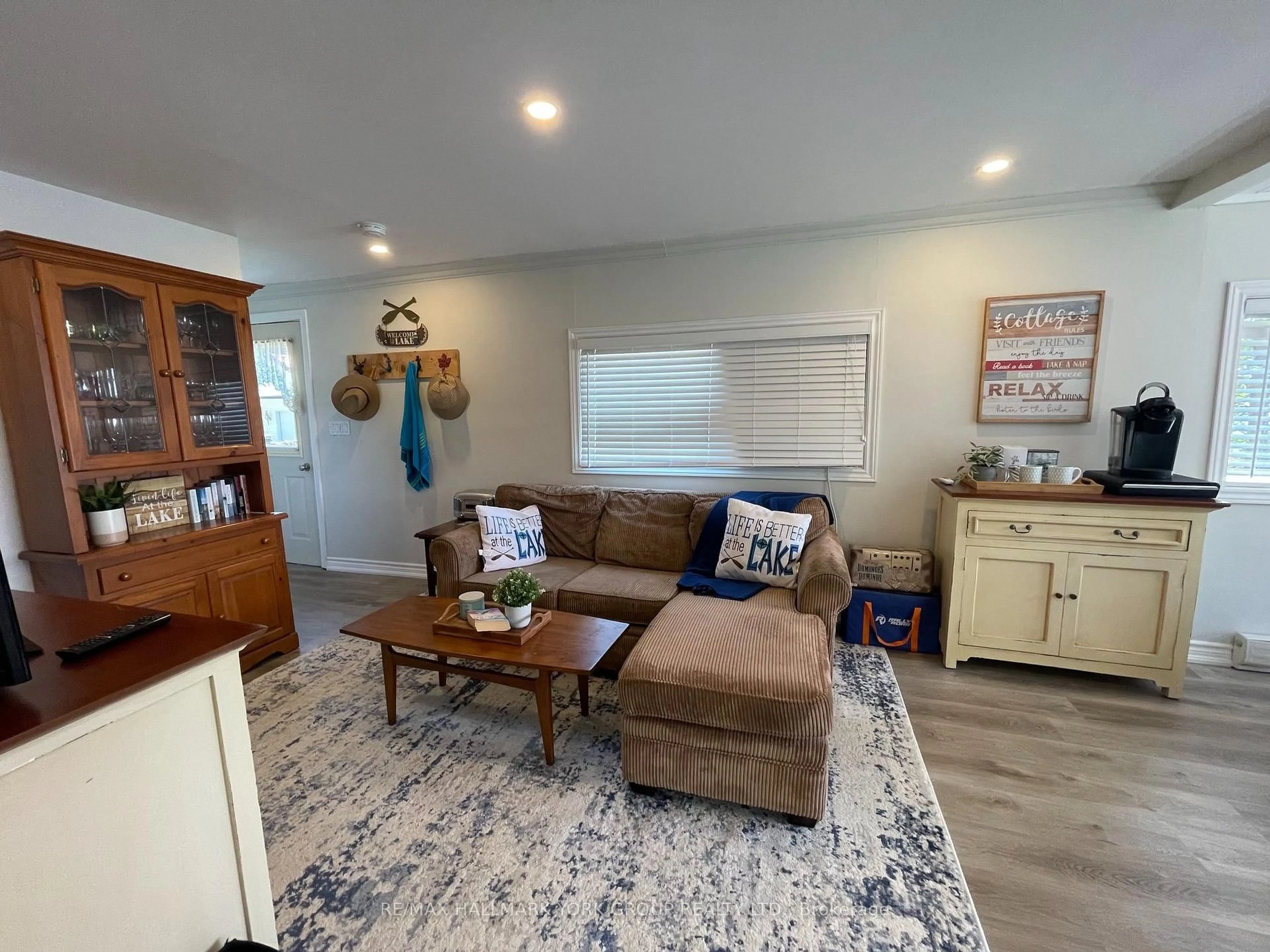 Living room with furniture, wood/laminate floor for 4464 Plum Point Rd, Ramara Ontario L0K 2B0