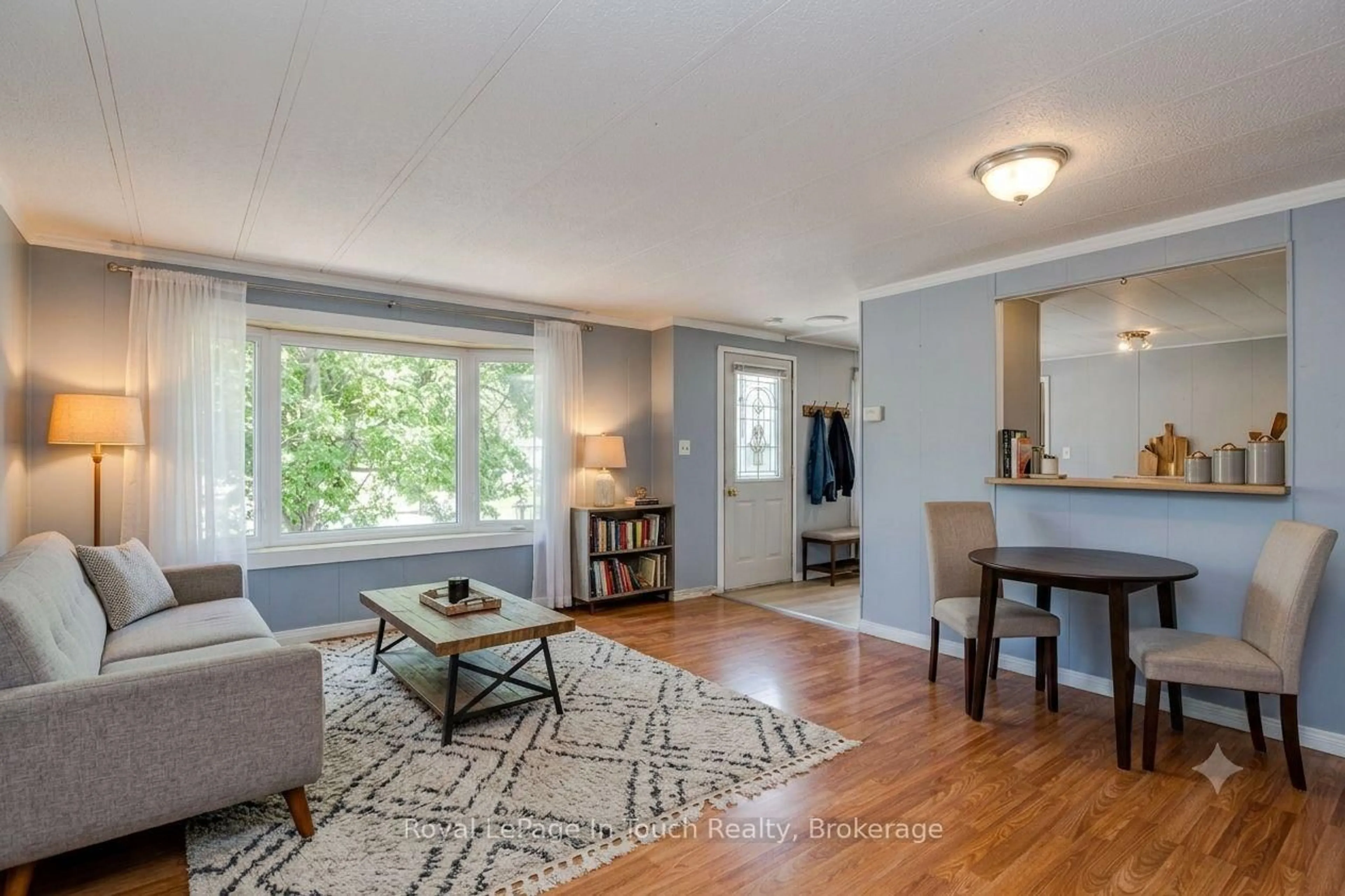 Living room with furniture, wood/laminate floor for 21 Vics Rd, Midland Ontario L4R 4K3