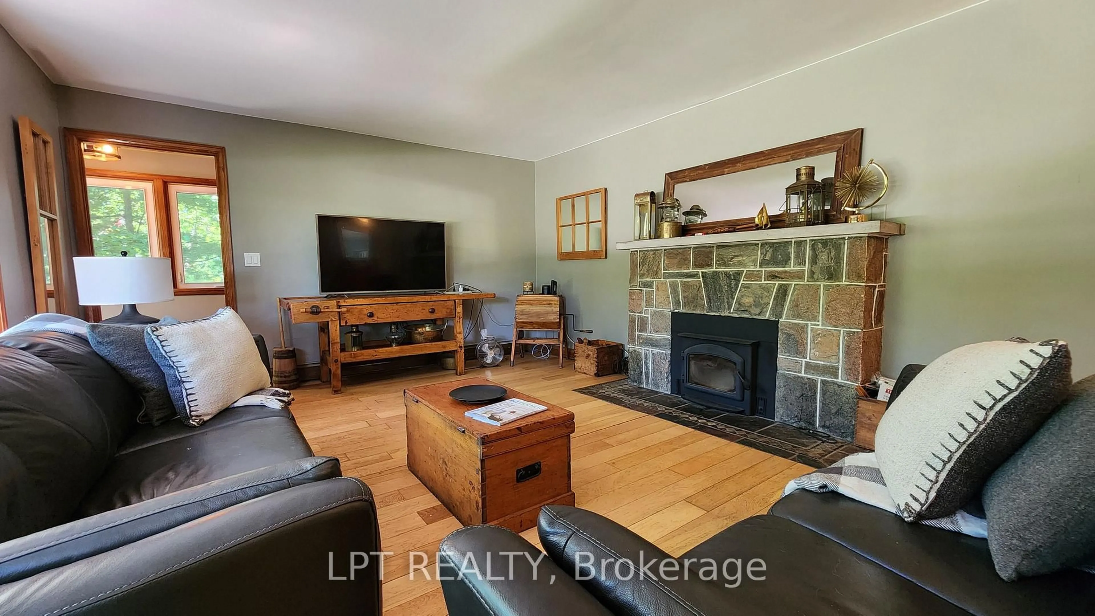 Living room with furniture, wood/laminate floor for 1644 Ridge Rd, Oro-Medonte Ontario L0L 1T0