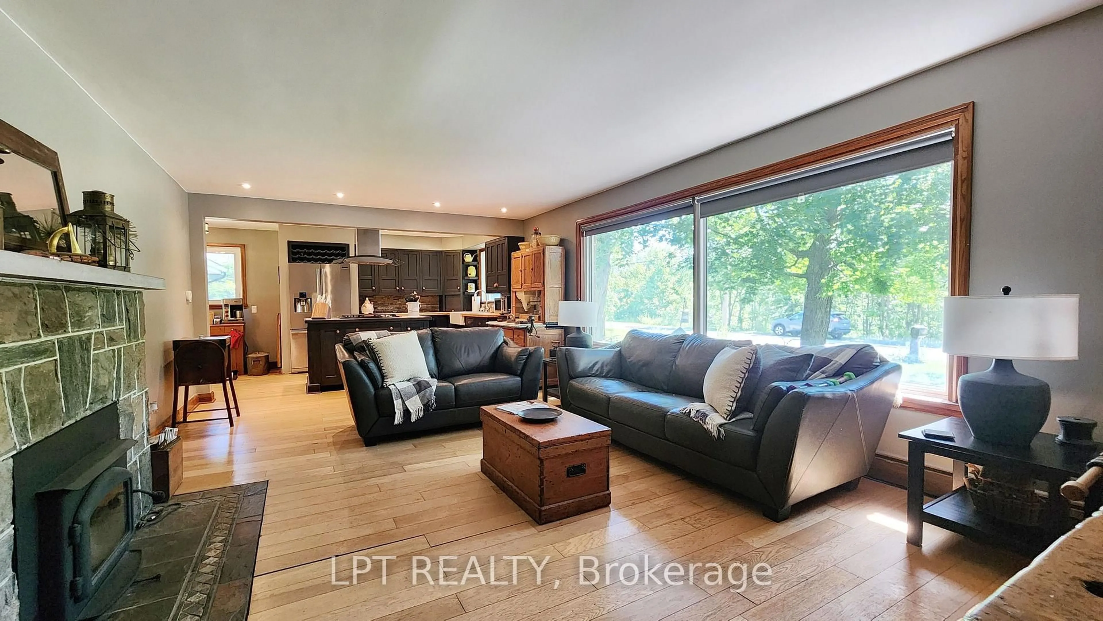Living room with furniture, wood/laminate floor for 1644 Ridge Rd, Oro-Medonte Ontario L0L 1T0