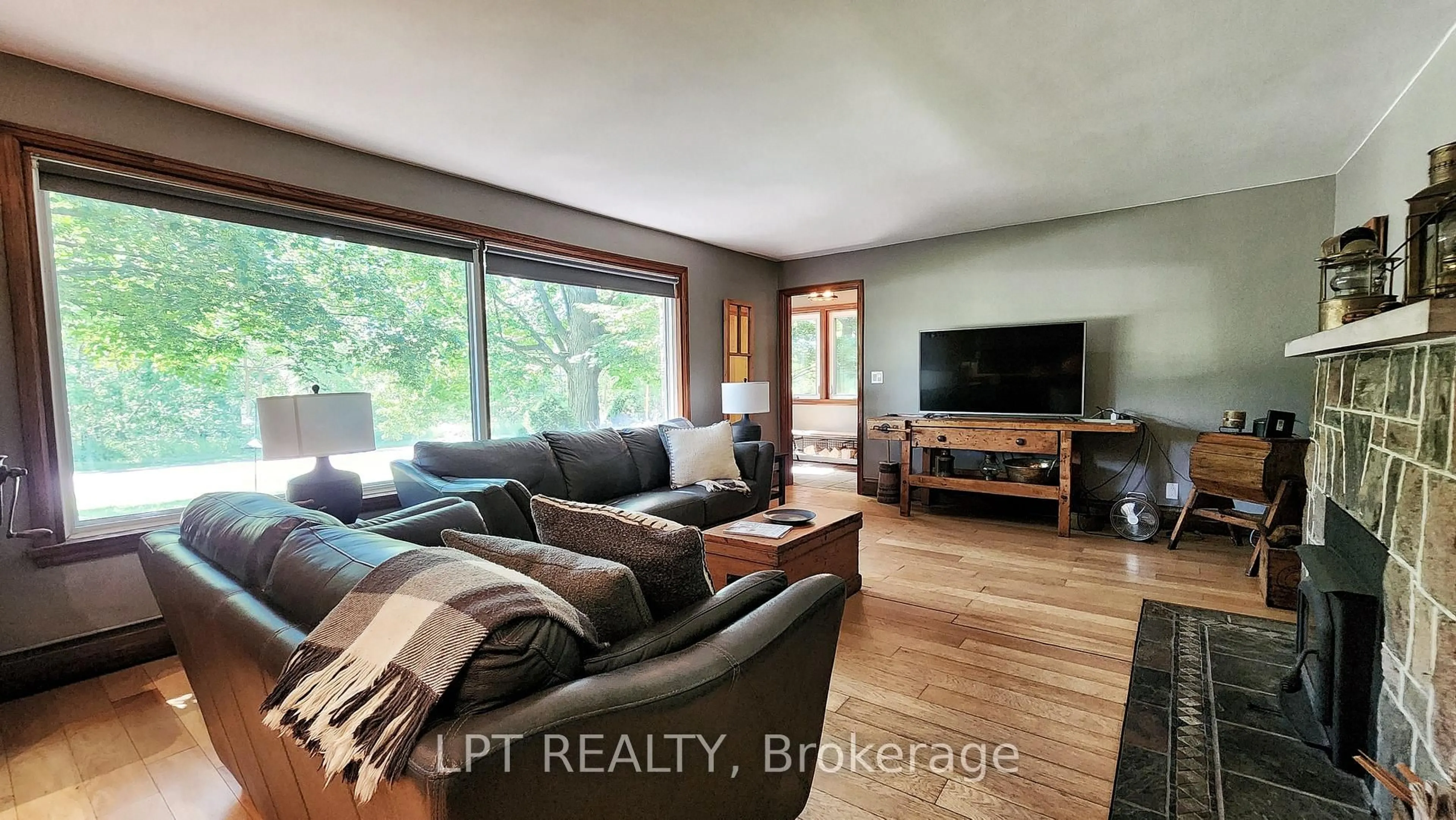 Living room with furniture, wood/laminate floor for 1644 Ridge Rd, Oro-Medonte Ontario L0L 1T0