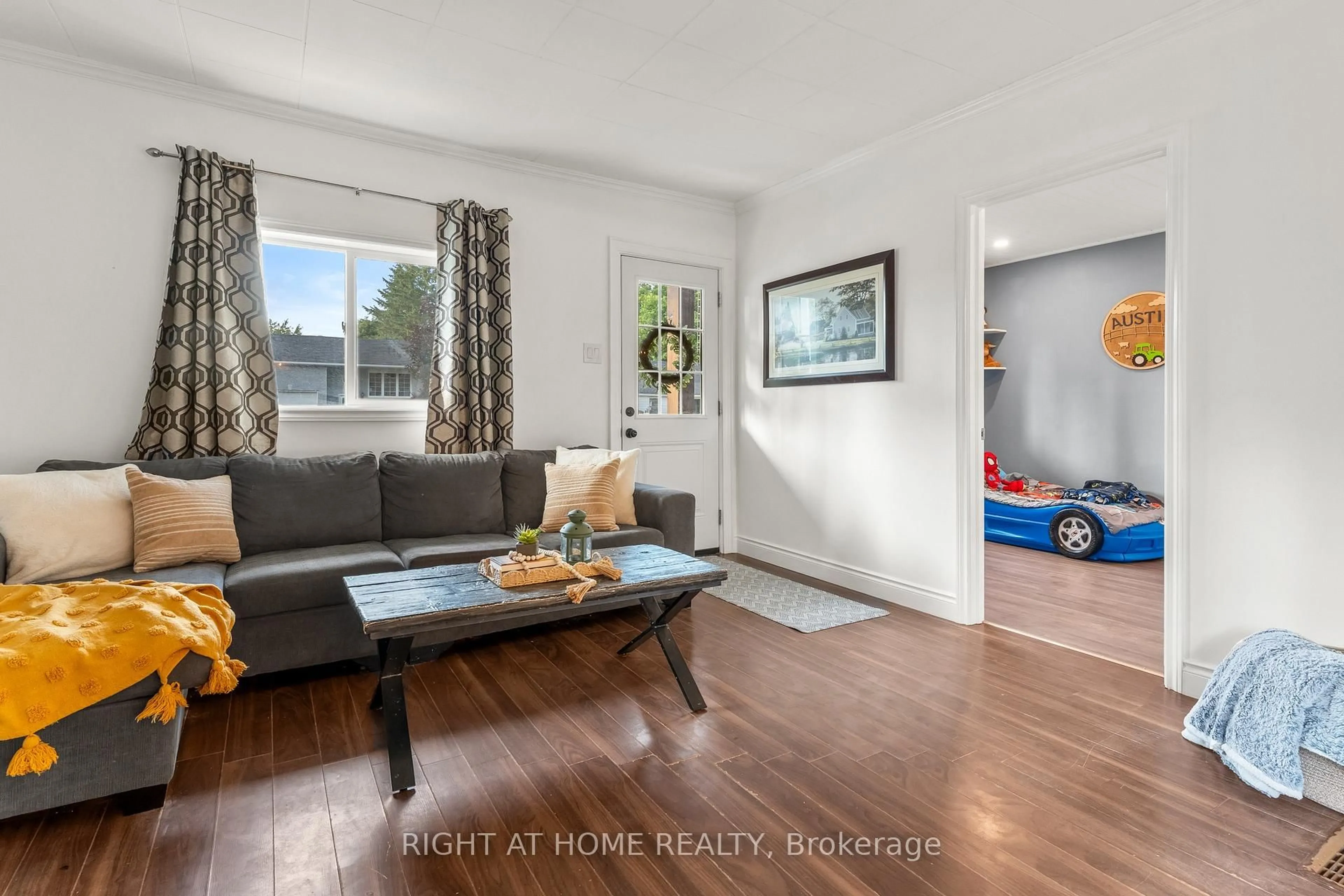 Living room with furniture, wood/laminate floor for 5317 County 9 Rd, Clearview Ontario L0M 1N0