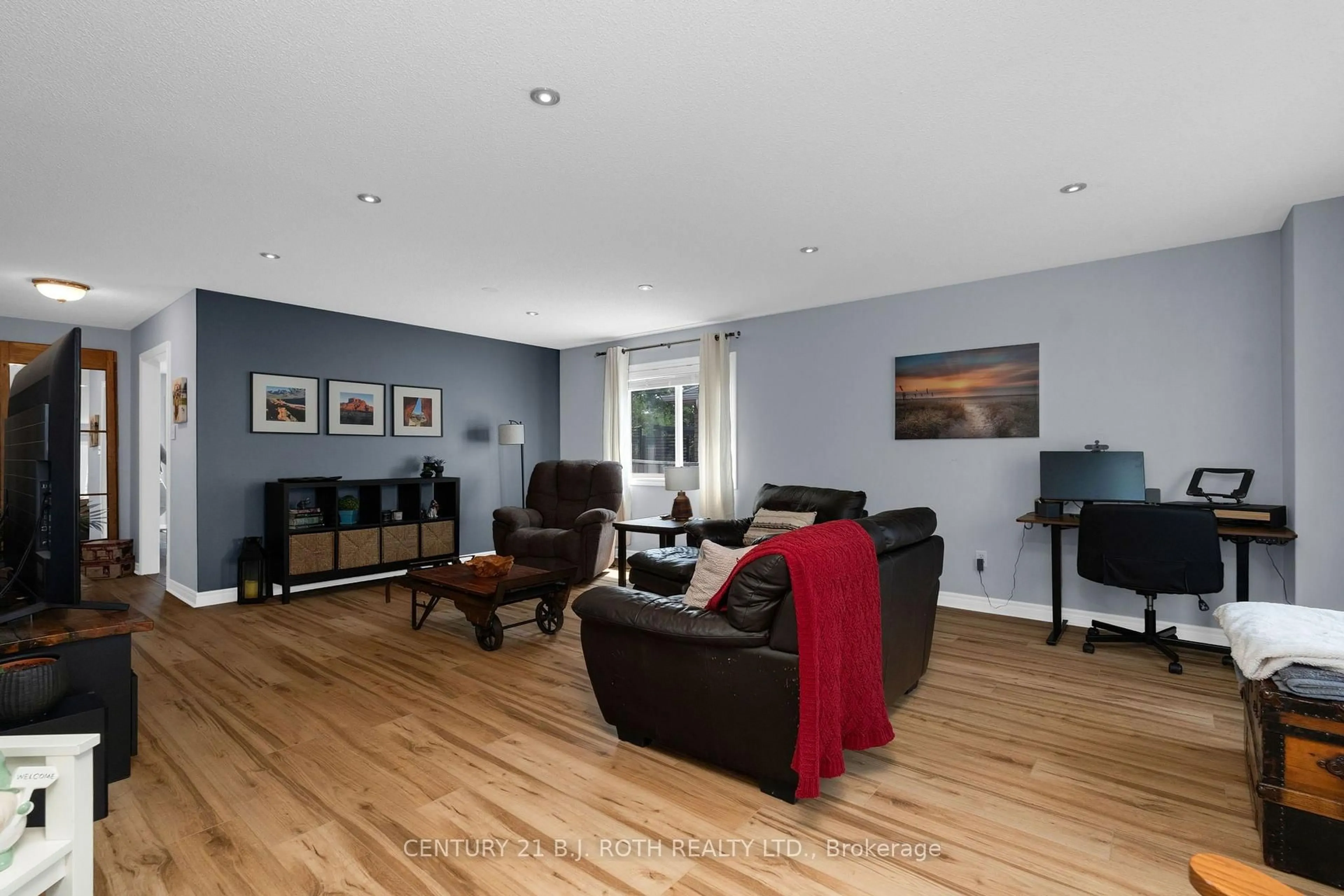 Living room with furniture, wood/laminate floor for 15 Corbett St, Springwater Ontario L0L 1P0