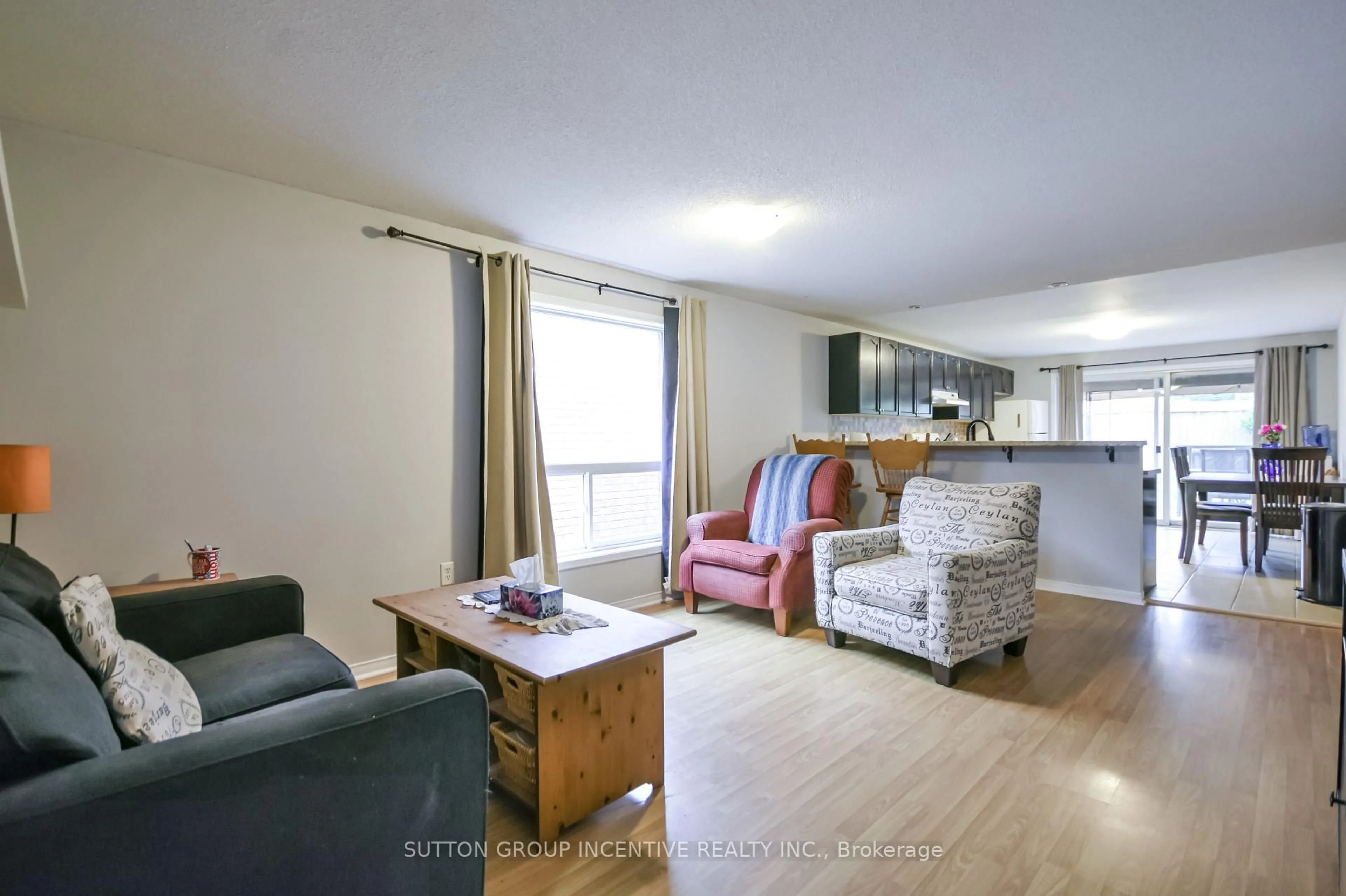 Living room with furniture, wood/laminate floor for 22 Peregrine Rd, Barrie Ontario L4M 6P9