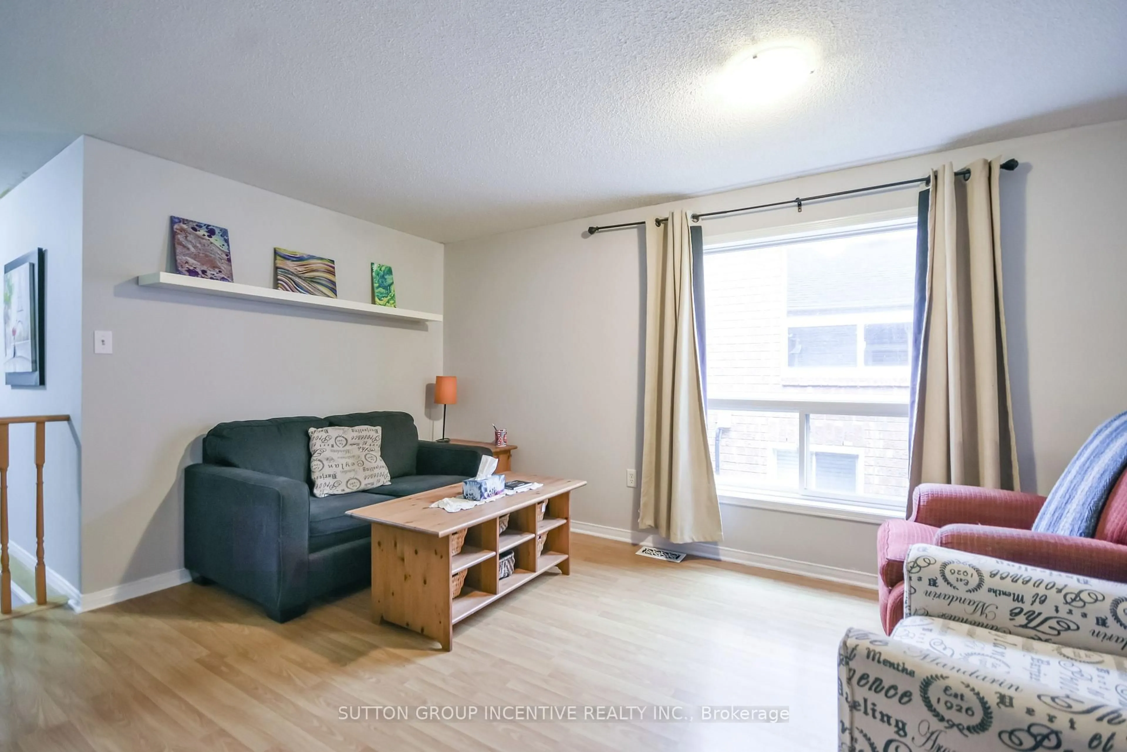 Living room with furniture, wood/laminate floor for 22 Peregrine Rd, Barrie Ontario L4M 6P9