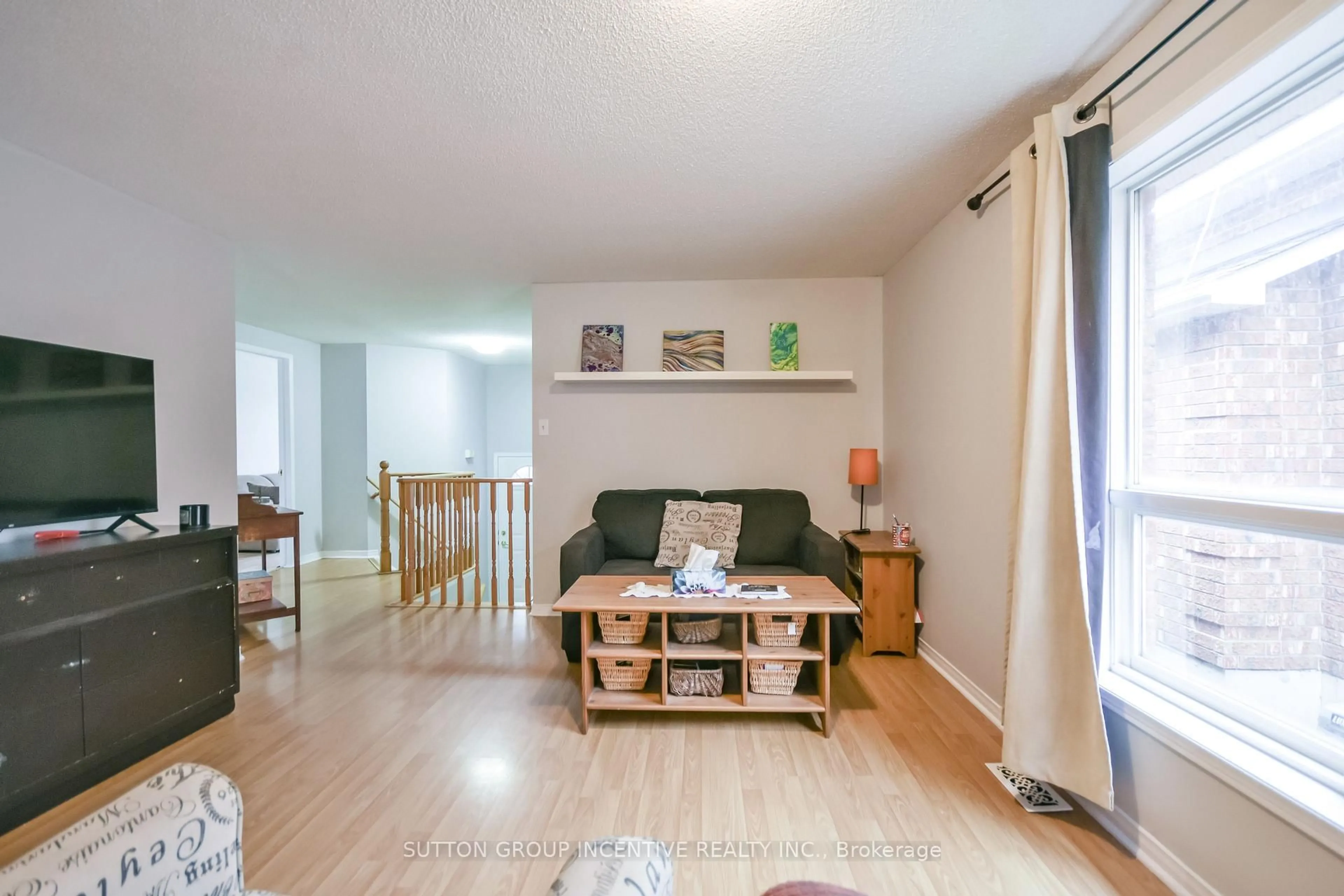 Living room with furniture, wood/laminate floor for 22 Peregrine Rd, Barrie Ontario L4M 6P9