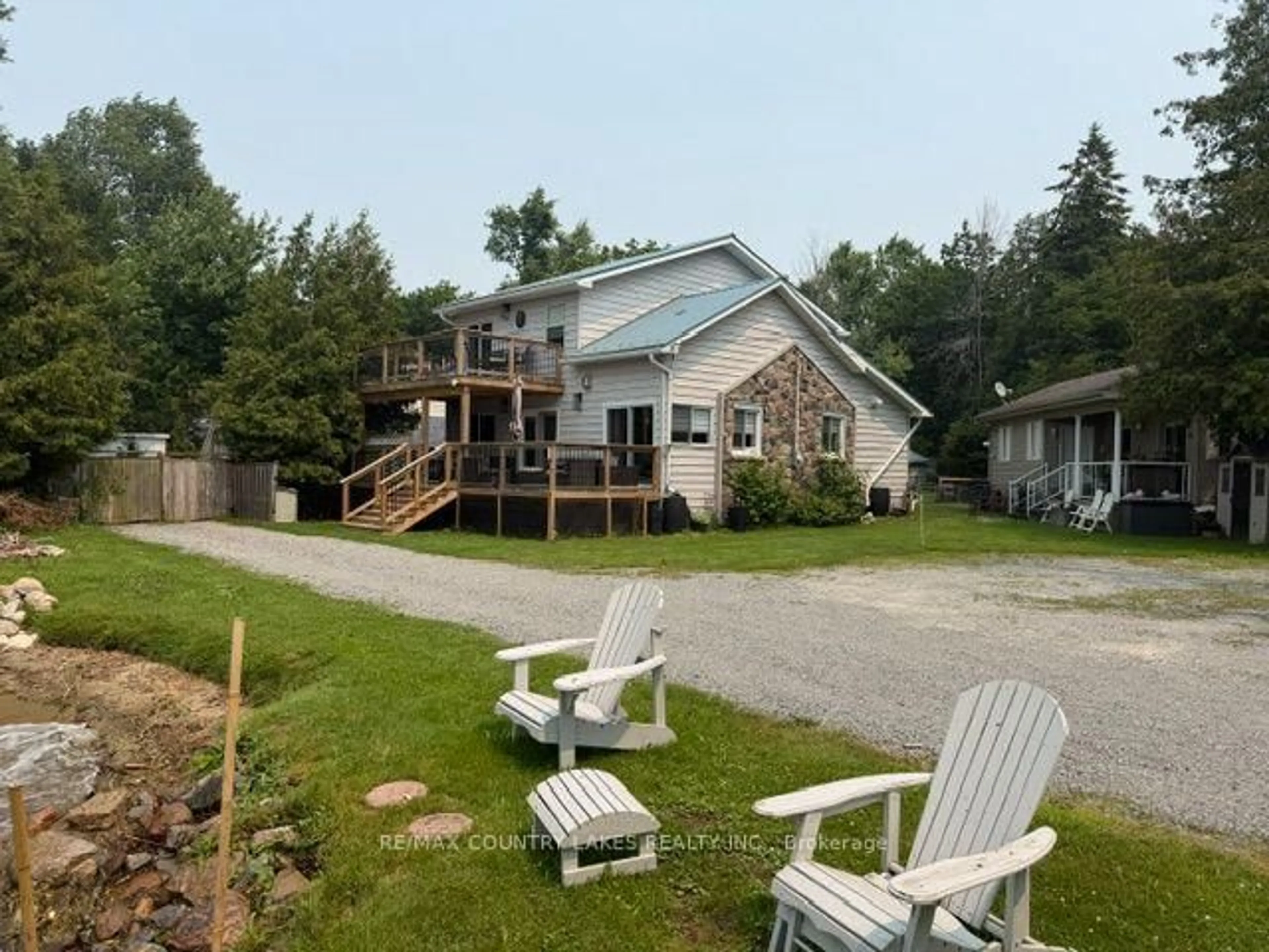 A pic from outside/outdoor area/front of a property/back of a property/a pic from drone, water/lake/river/ocean view for 104 The Steps Rd, Ramara Ontario L0K 1B0