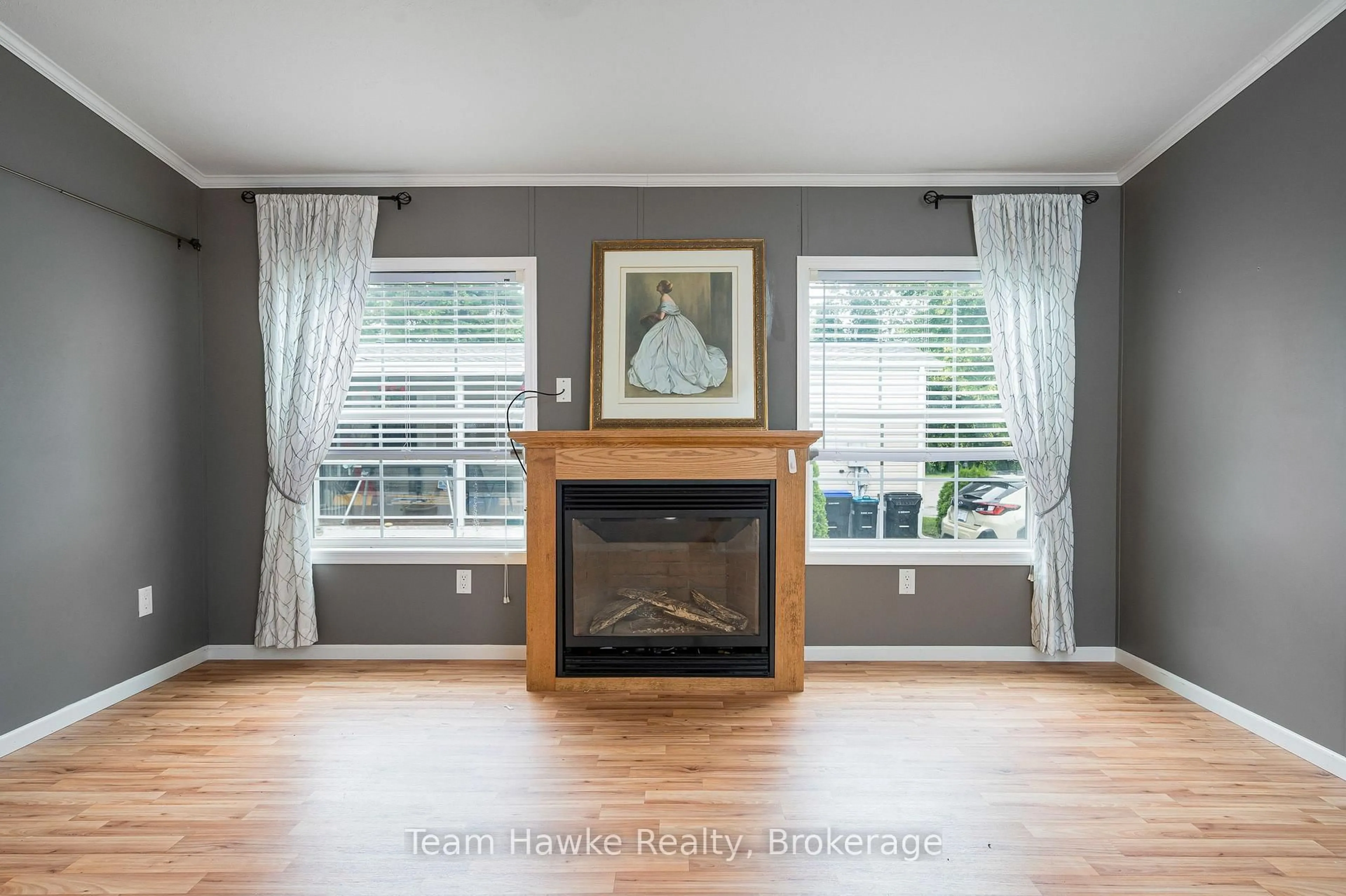 Living room with furniture, wood/laminate floor for 97 Georgian Glen Dr, Wasaga Beach Ontario L9Z 1K8