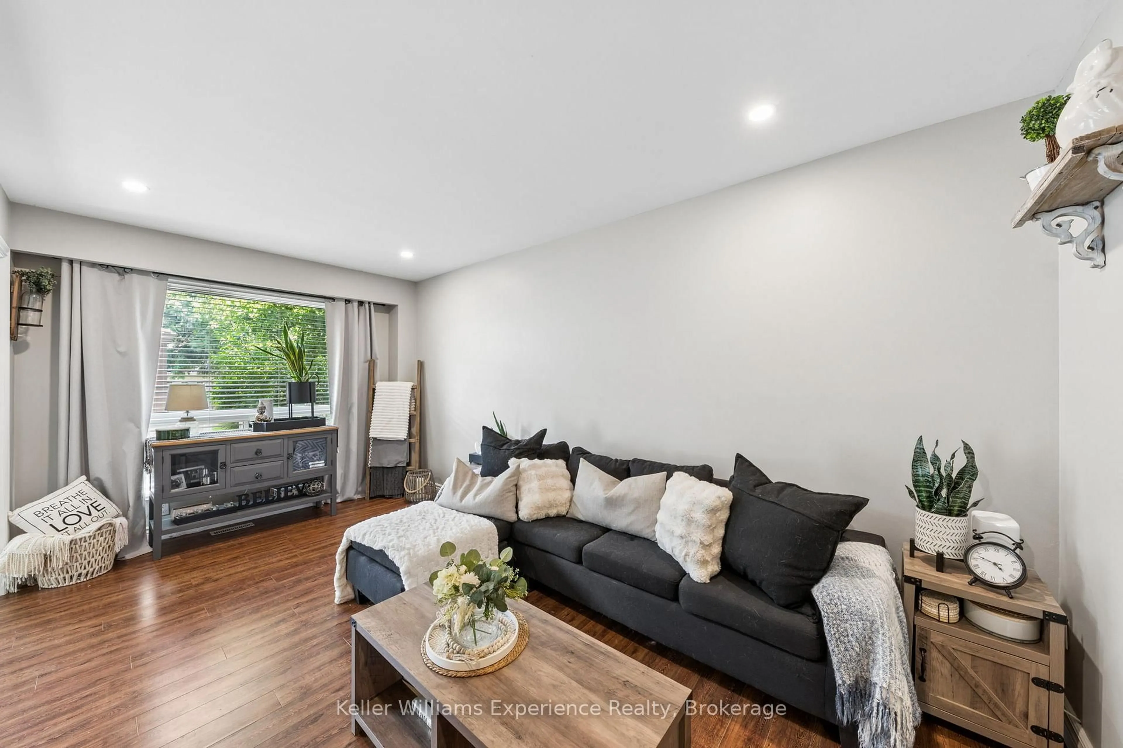 Living room with furniture, wood/laminate floor for 2 Bernick Dr #23, Barrie Ontario L4M 5K4