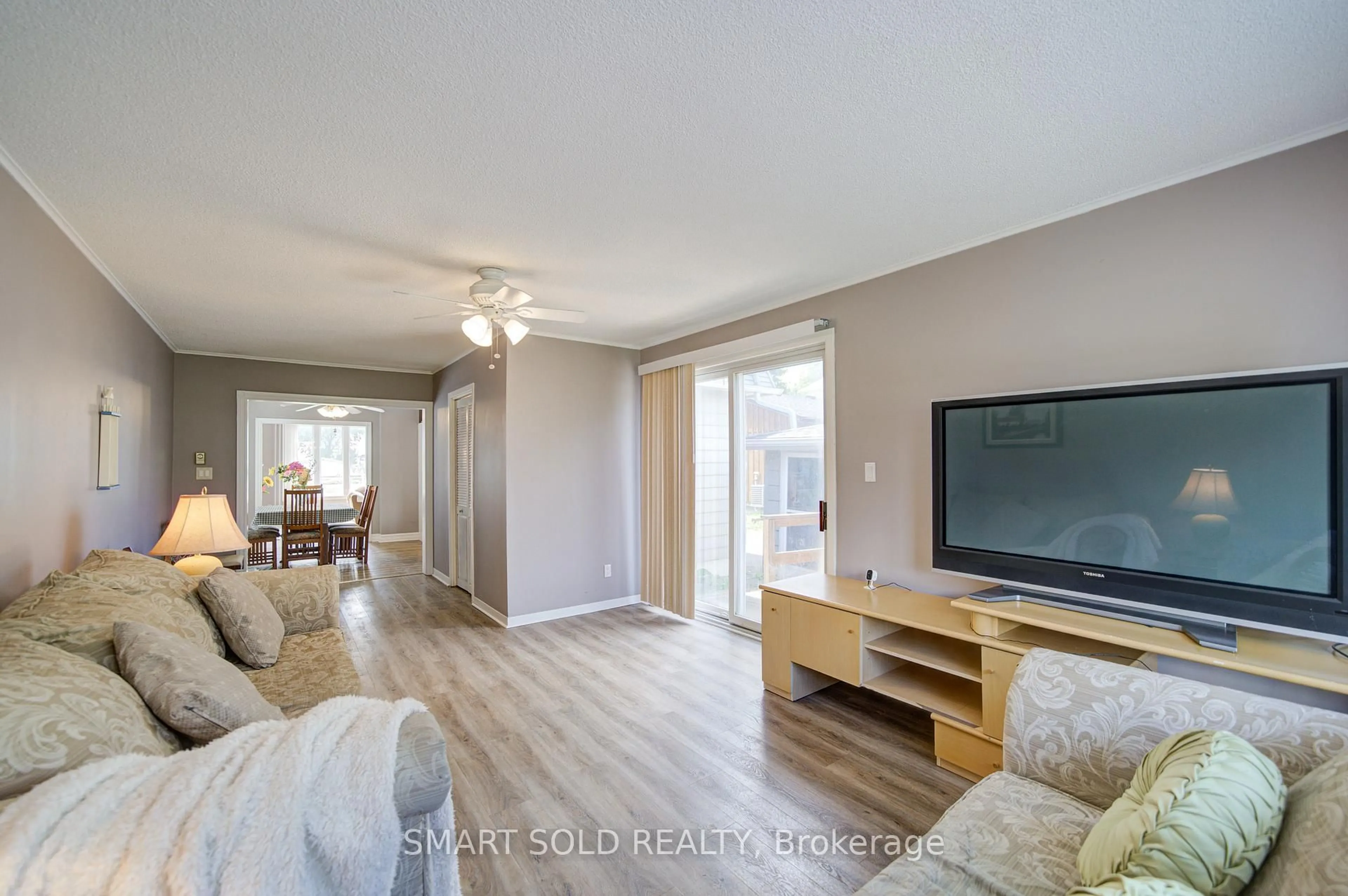 Living room with furniture, wood/laminate floor for 75 Lake Ave, Ramara Ontario L0K 1B0