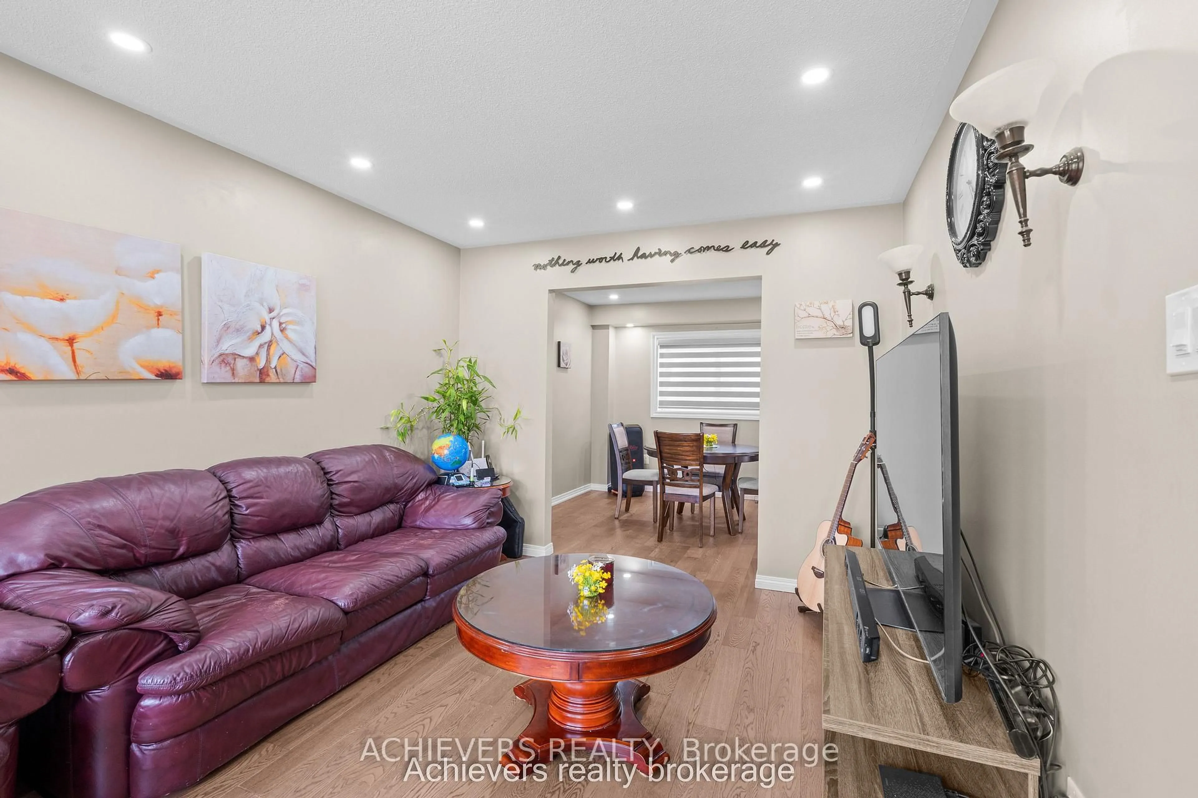 Living room with furniture, wood/laminate floor for 66 Leggott Ave, Barrie Ontario L4N 8B7