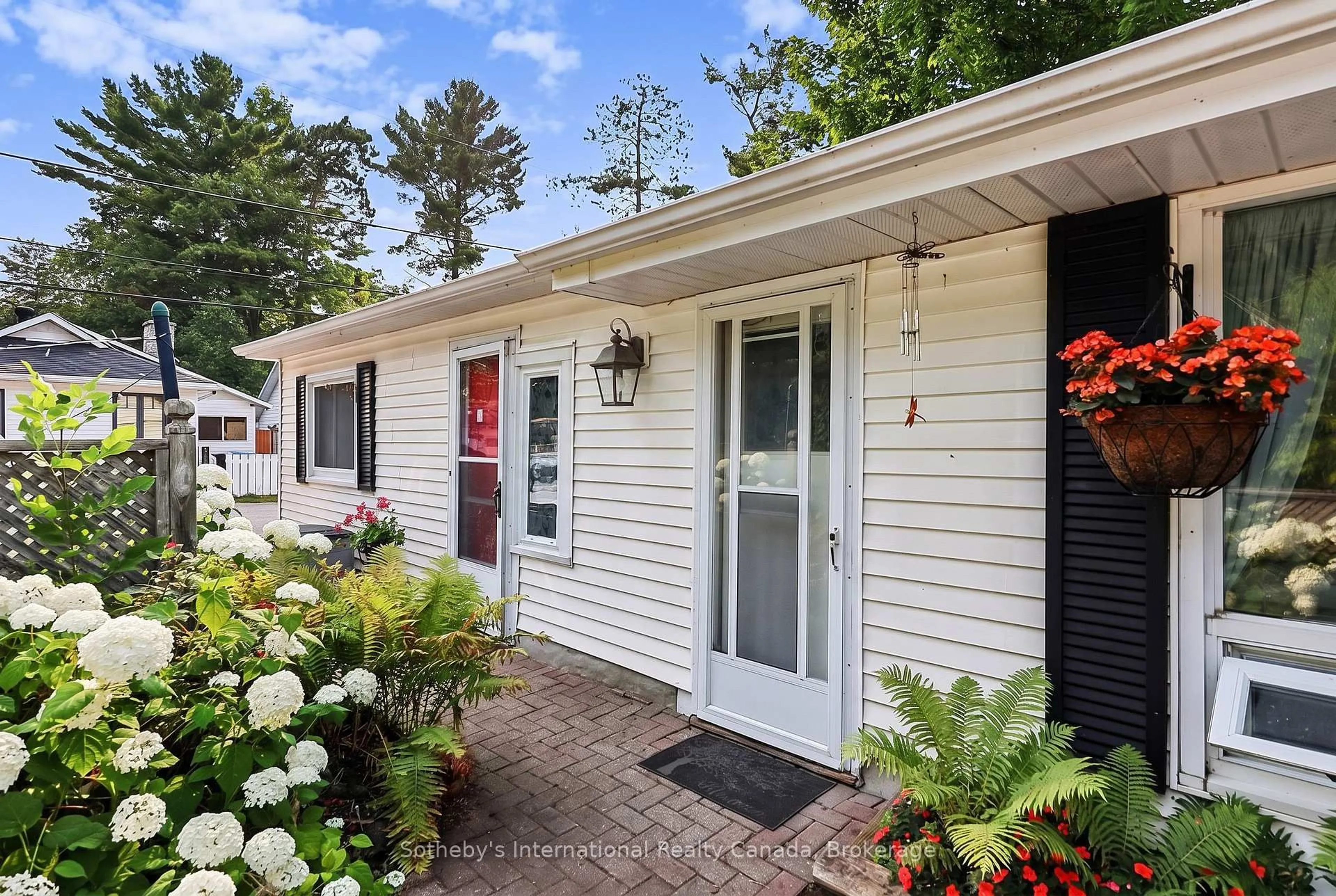 Home with vinyl exterior material, street for 32 Tiny Beaches Rd, Tiny Ontario L0L 2J0