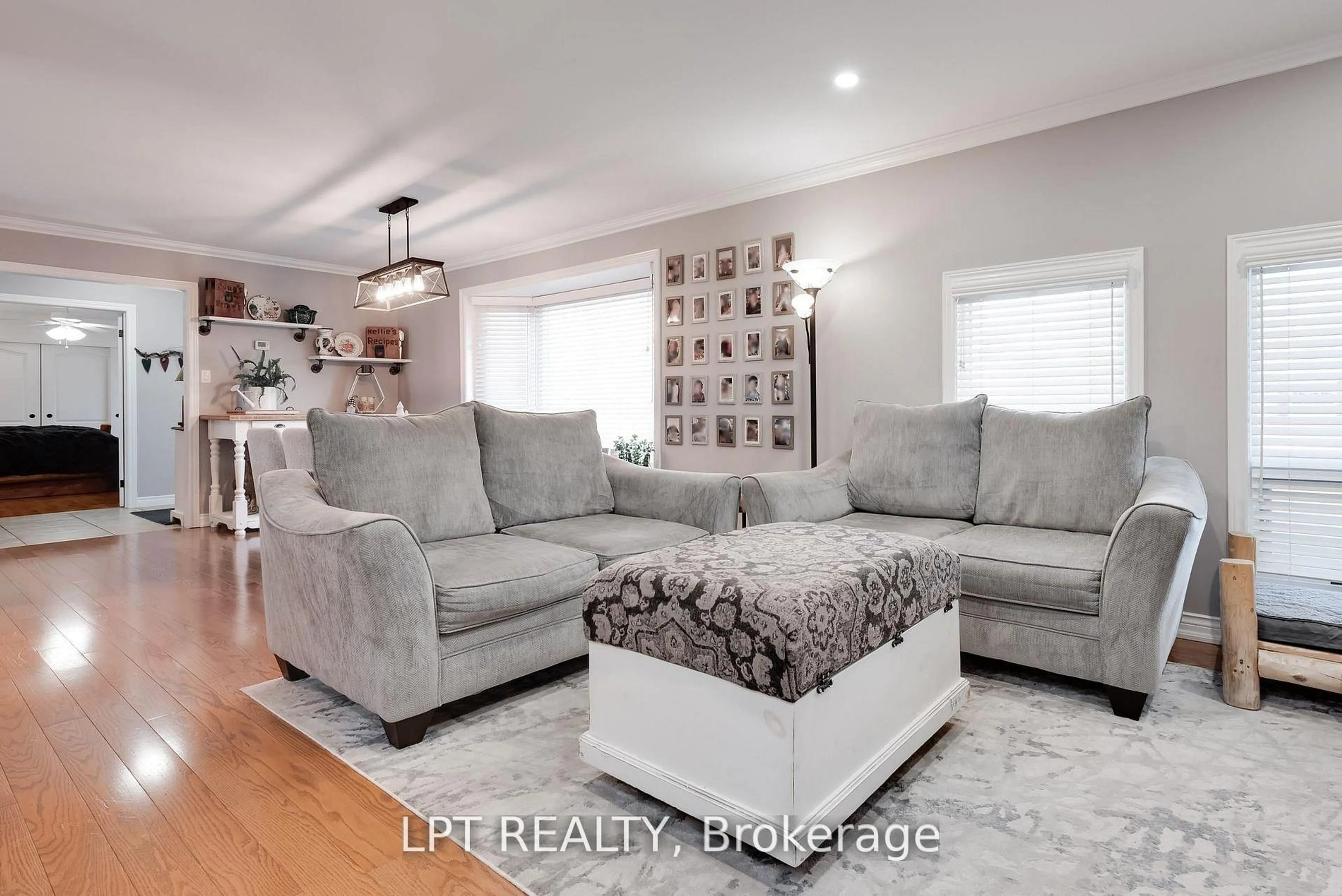 Living room with furniture, wood/laminate floor for 34 Cedar Creek Rd, Springwater Ontario L9X 0P5