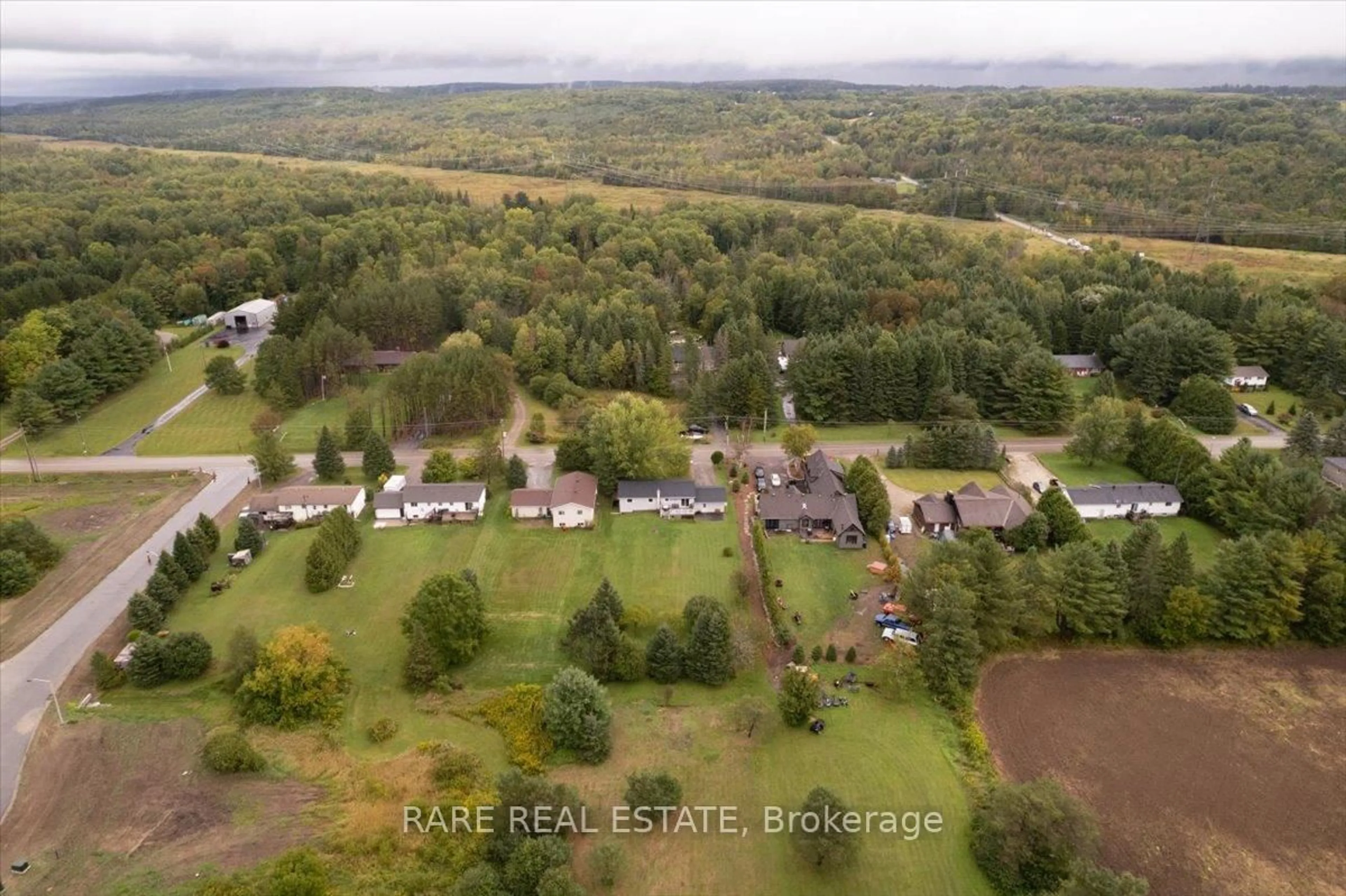 A pic from outside/outdoor area/front of a property/back of a property/a pic from drone, forest/trees view for 66 Scarlett Line, Springwater Ontario L0L 1V0