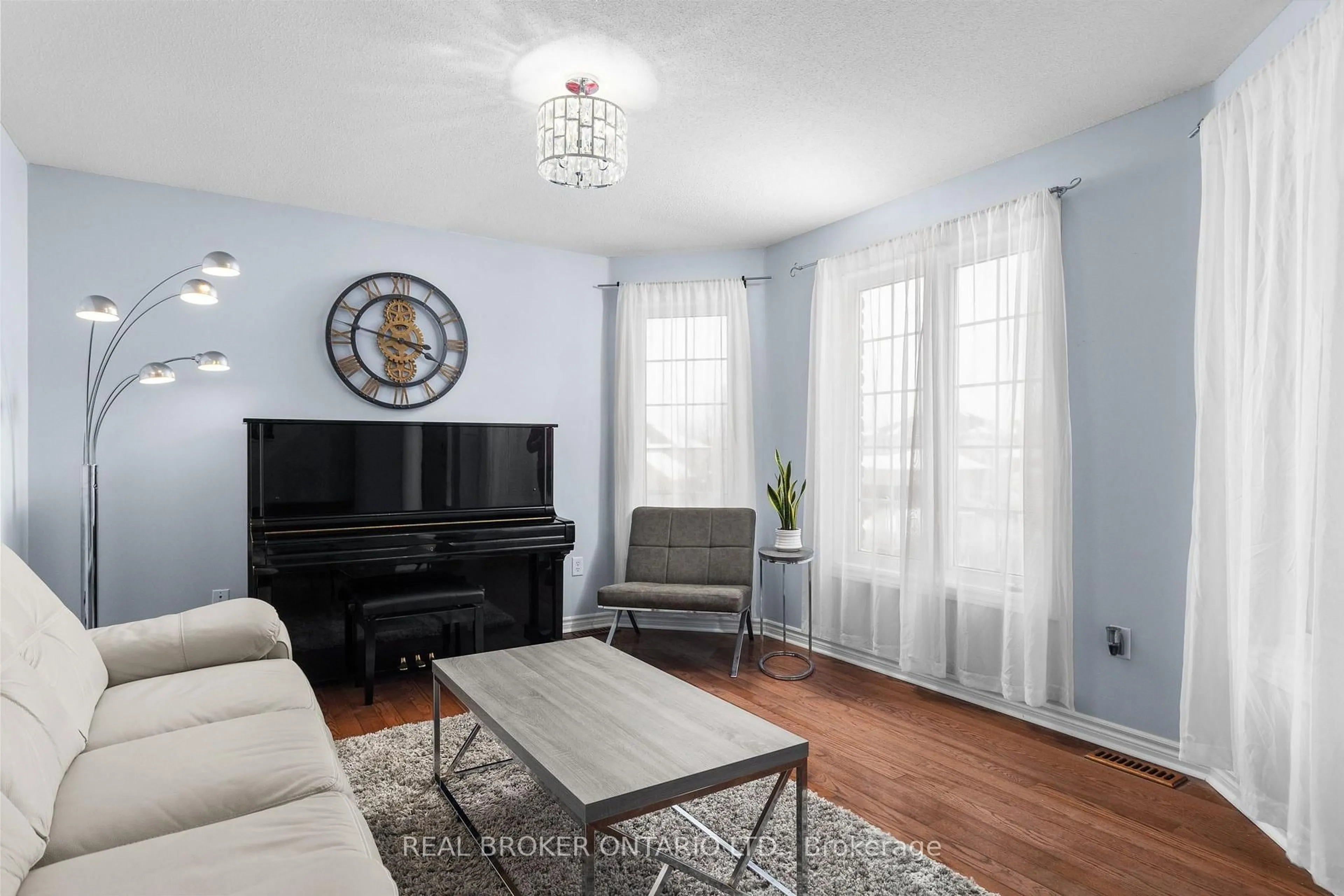 Living room with furniture, wood/laminate floor for 31 Bell St, Barrie Ontario L4N 0J2