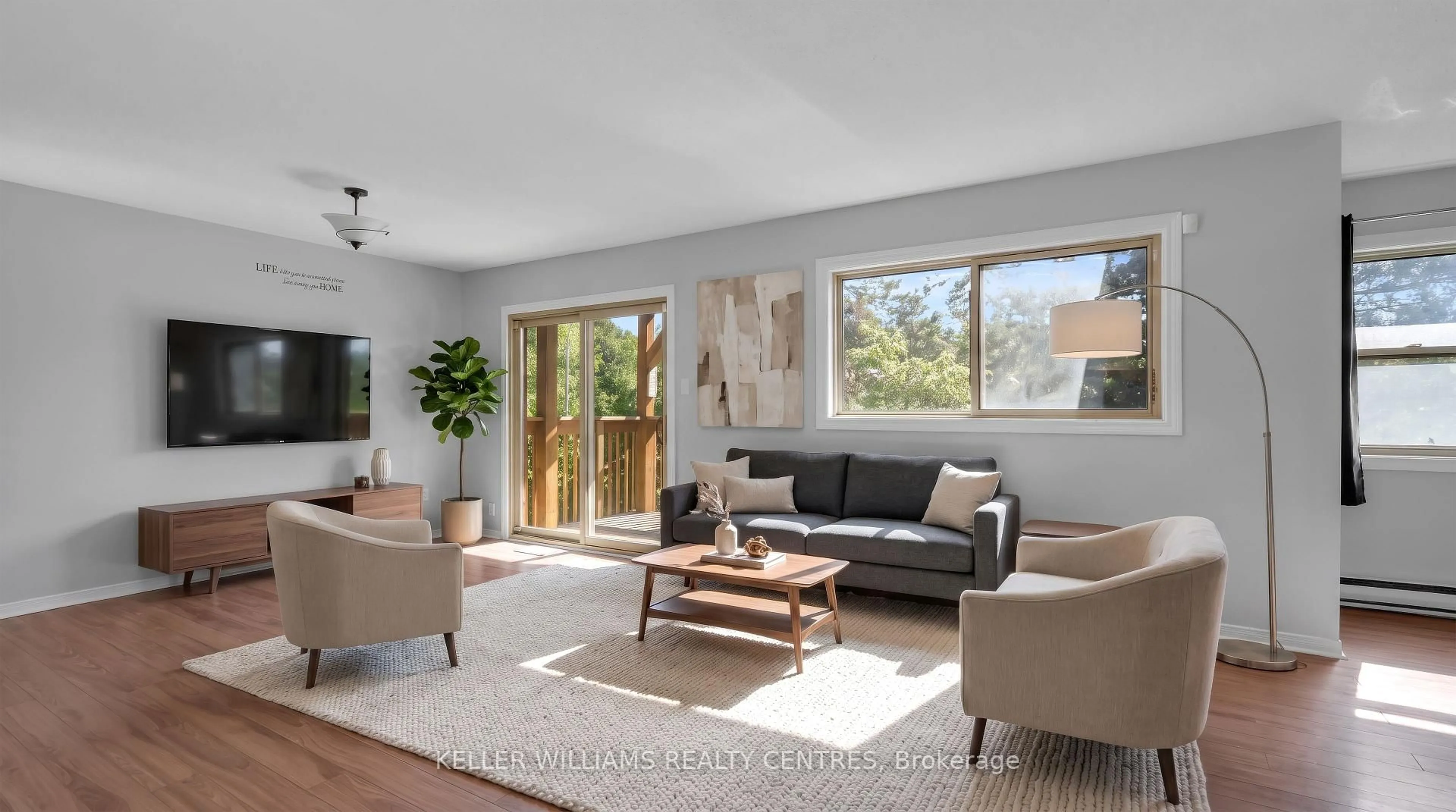 Living room with furniture, wood/laminate floor for 22 Meadow Lane #2, Barrie Ontario L4N 7K2