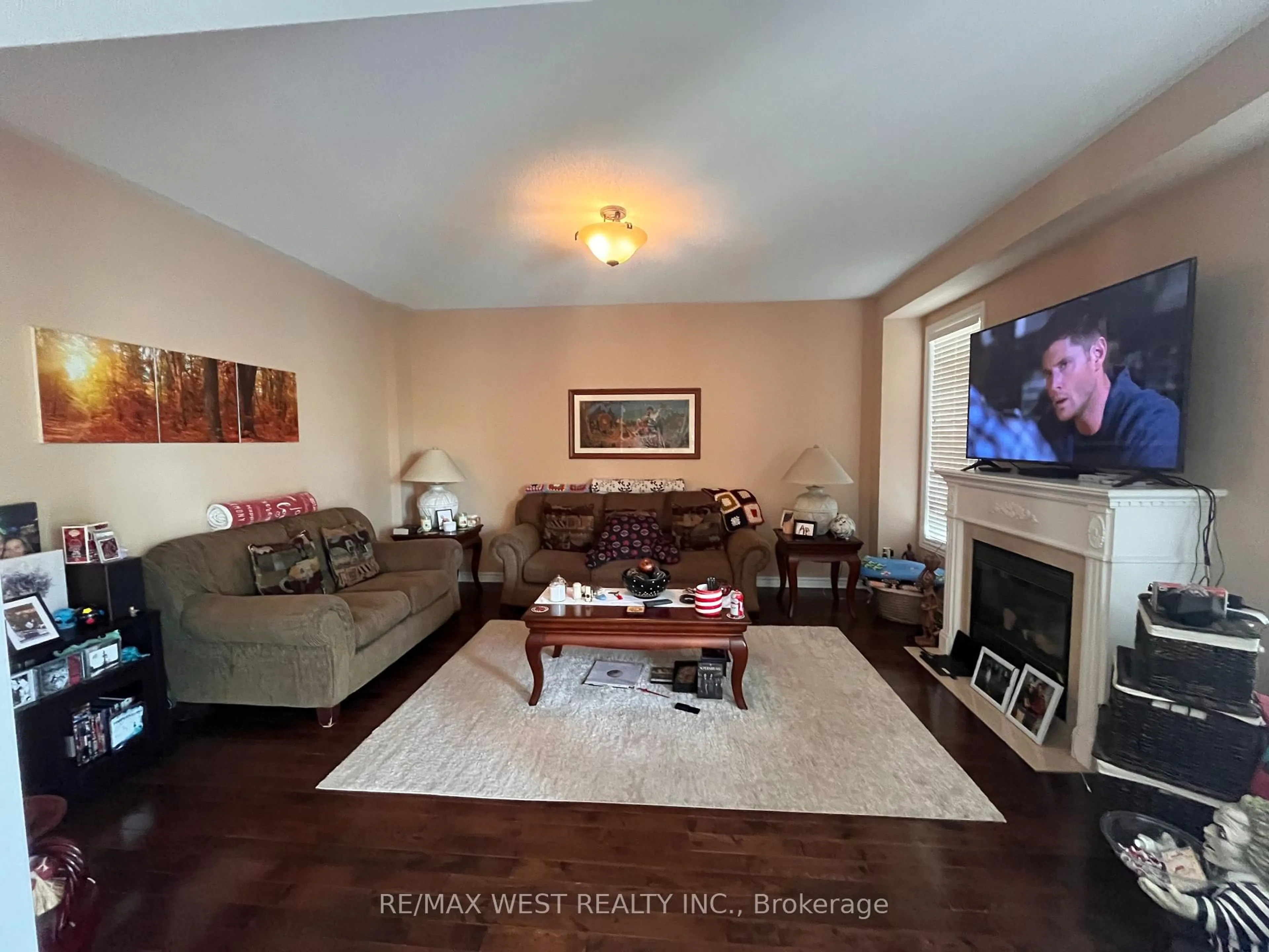 Living room with furniture, wood/laminate floor for 20 Regalia Way, Barrie Ontario L4M 7H7