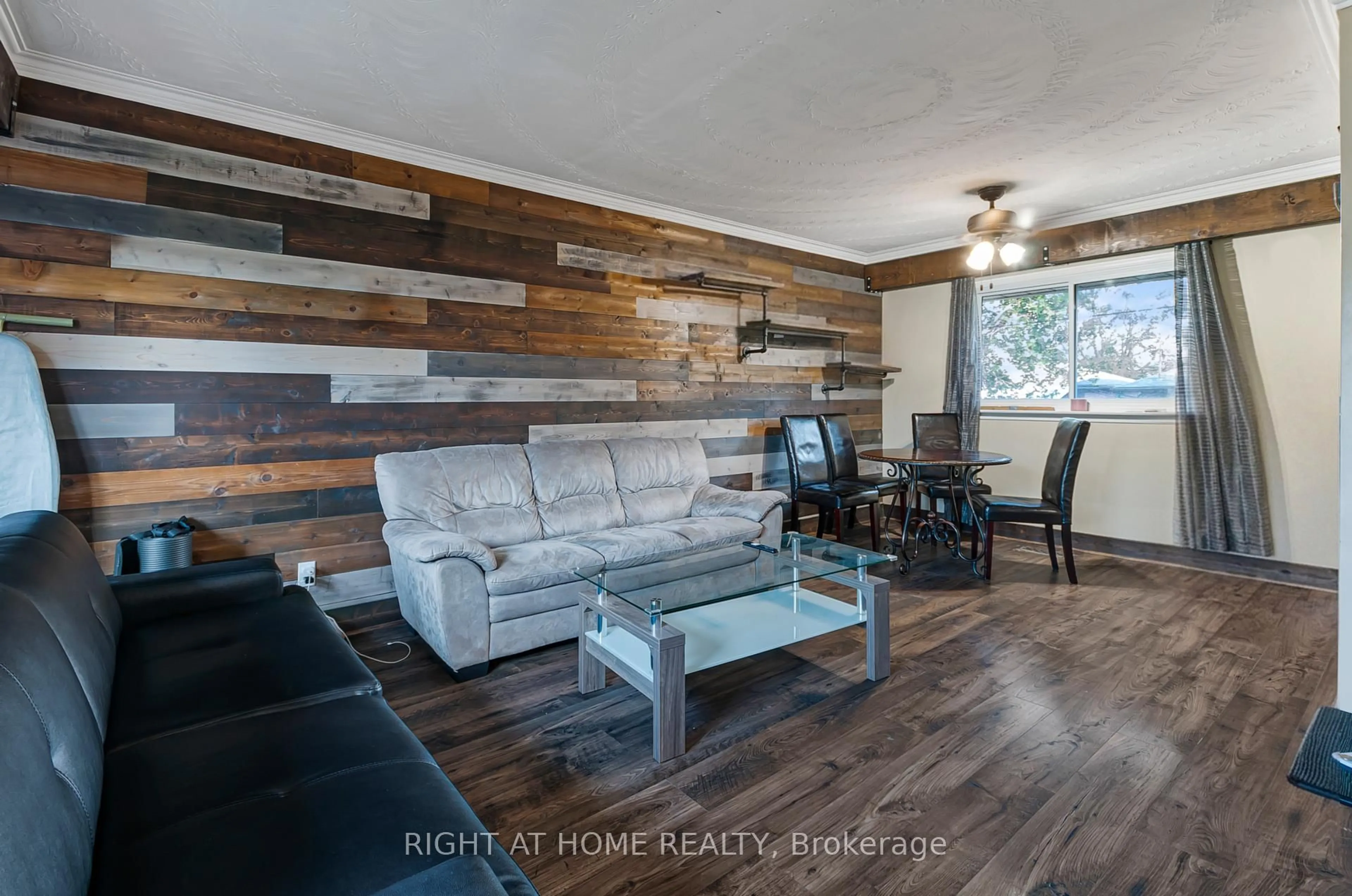 Living room with furniture, wood/laminate floor for 201 Steel St, Barrie Ontario L4M 2G8