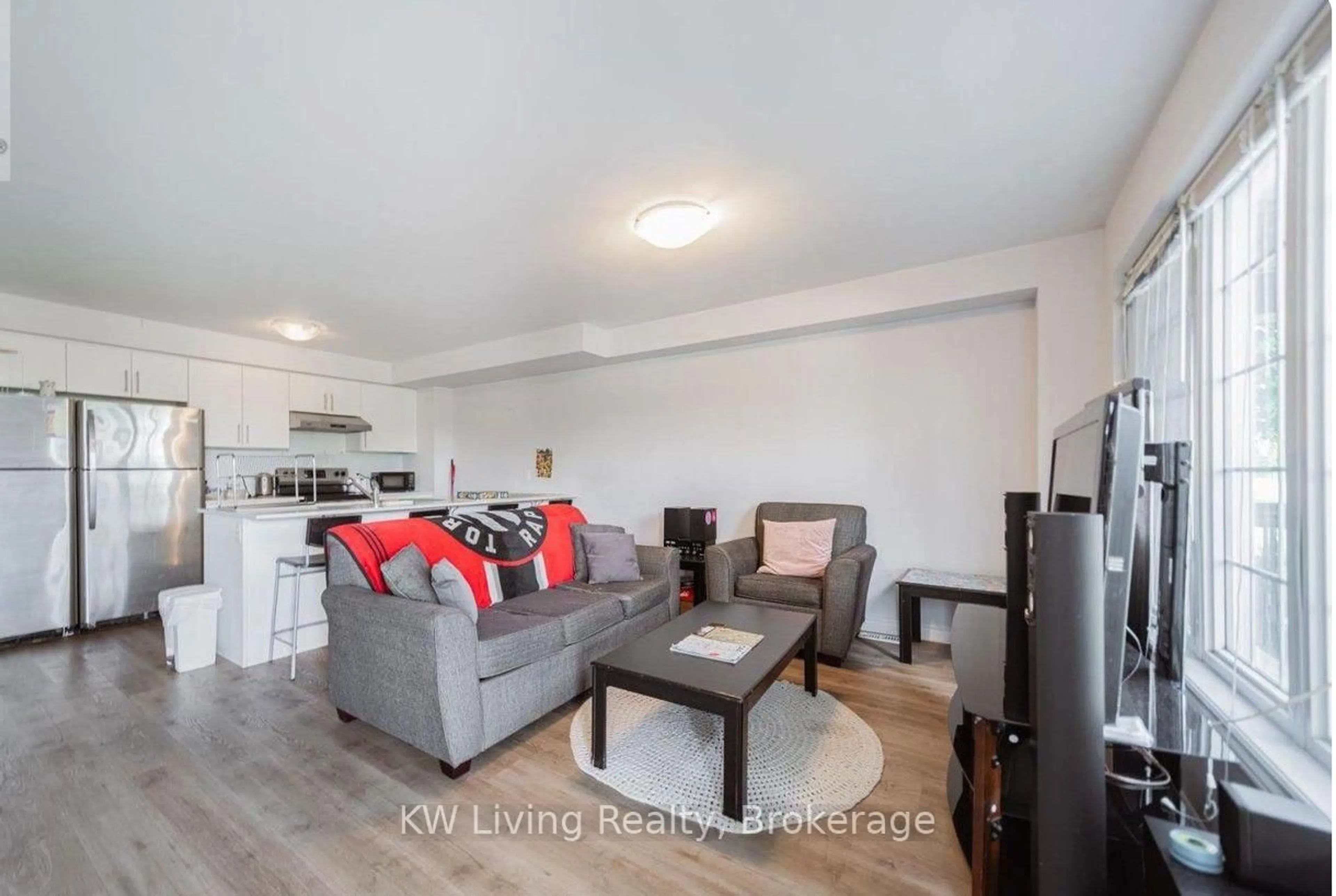 Living room with furniture, wood/laminate floor for 252 Penetanguishene Rd #10, Barrie Ontario L4M 7C2