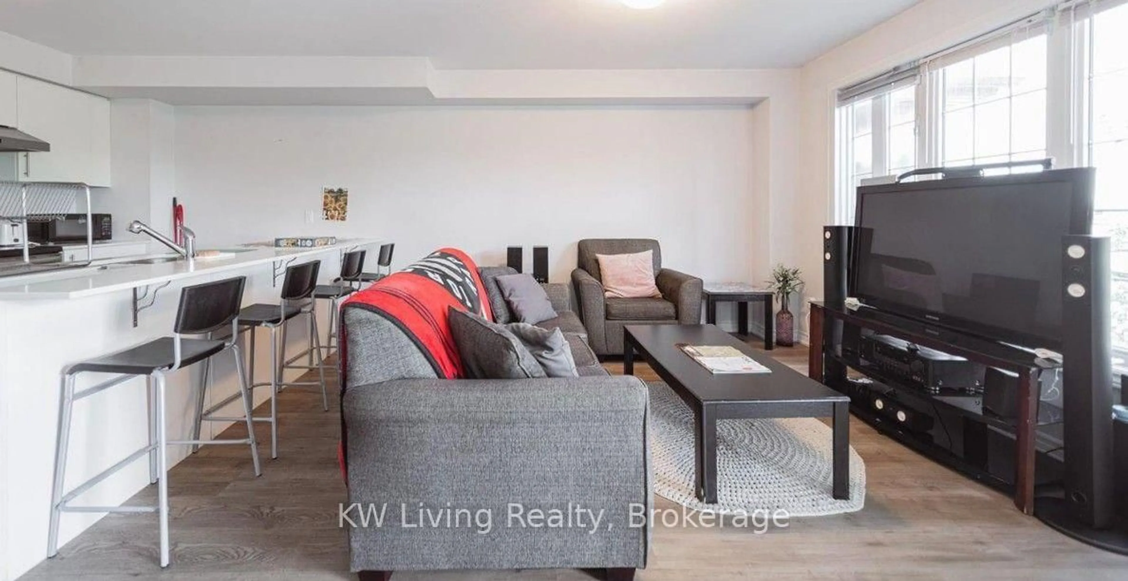 Living room with furniture, wood/laminate floor for 252 Penetanguishene Rd #10, Barrie Ontario L4M 7C2
