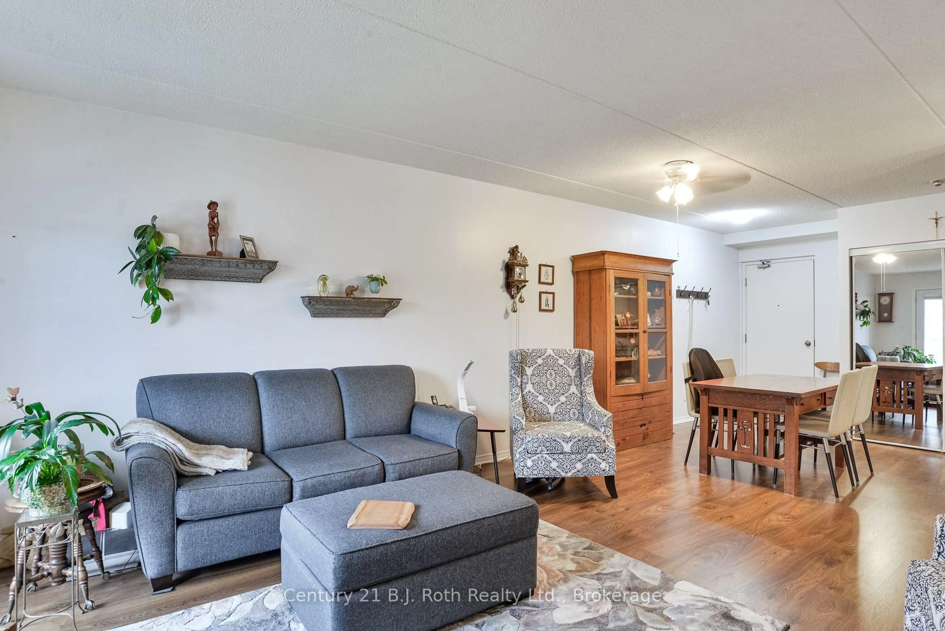 Living room with furniture, wood/laminate floor for 125 Bond St #207, Orillia Ontario L3V 1J7