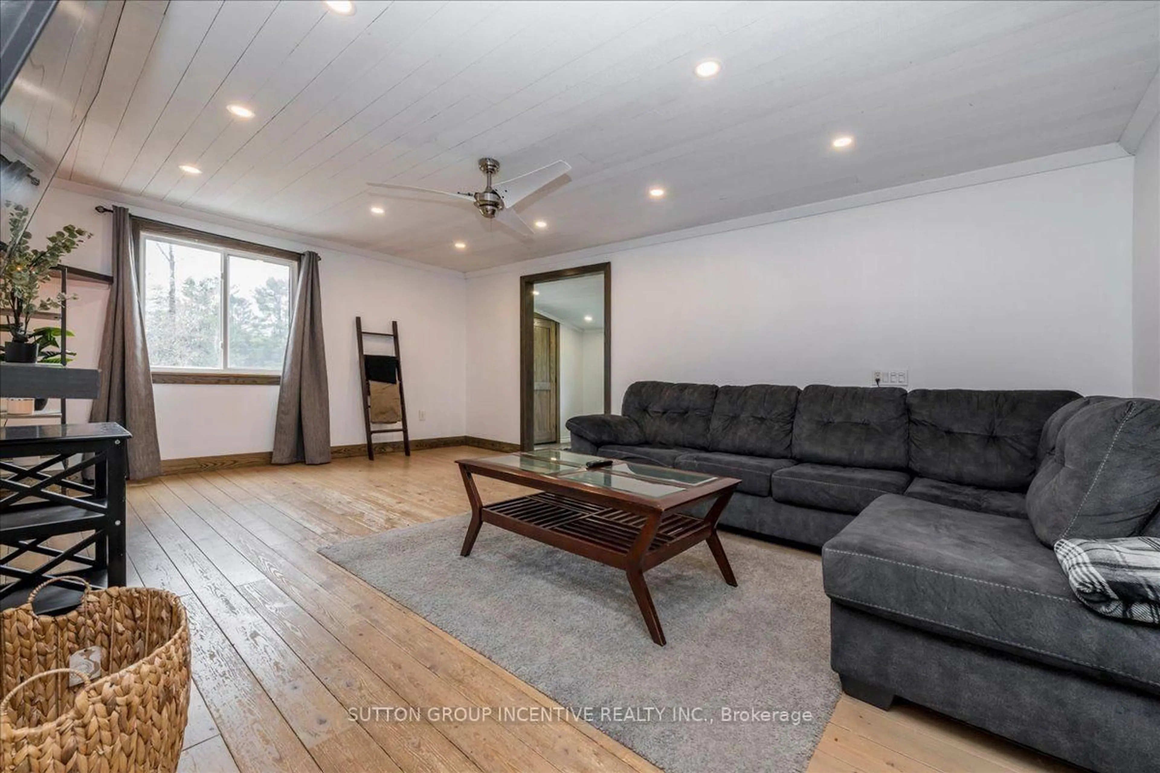 Living room with furniture, wood/laminate floor for 1823 Coopers Falls Rd, Ramara Ontario L0K 2B0
