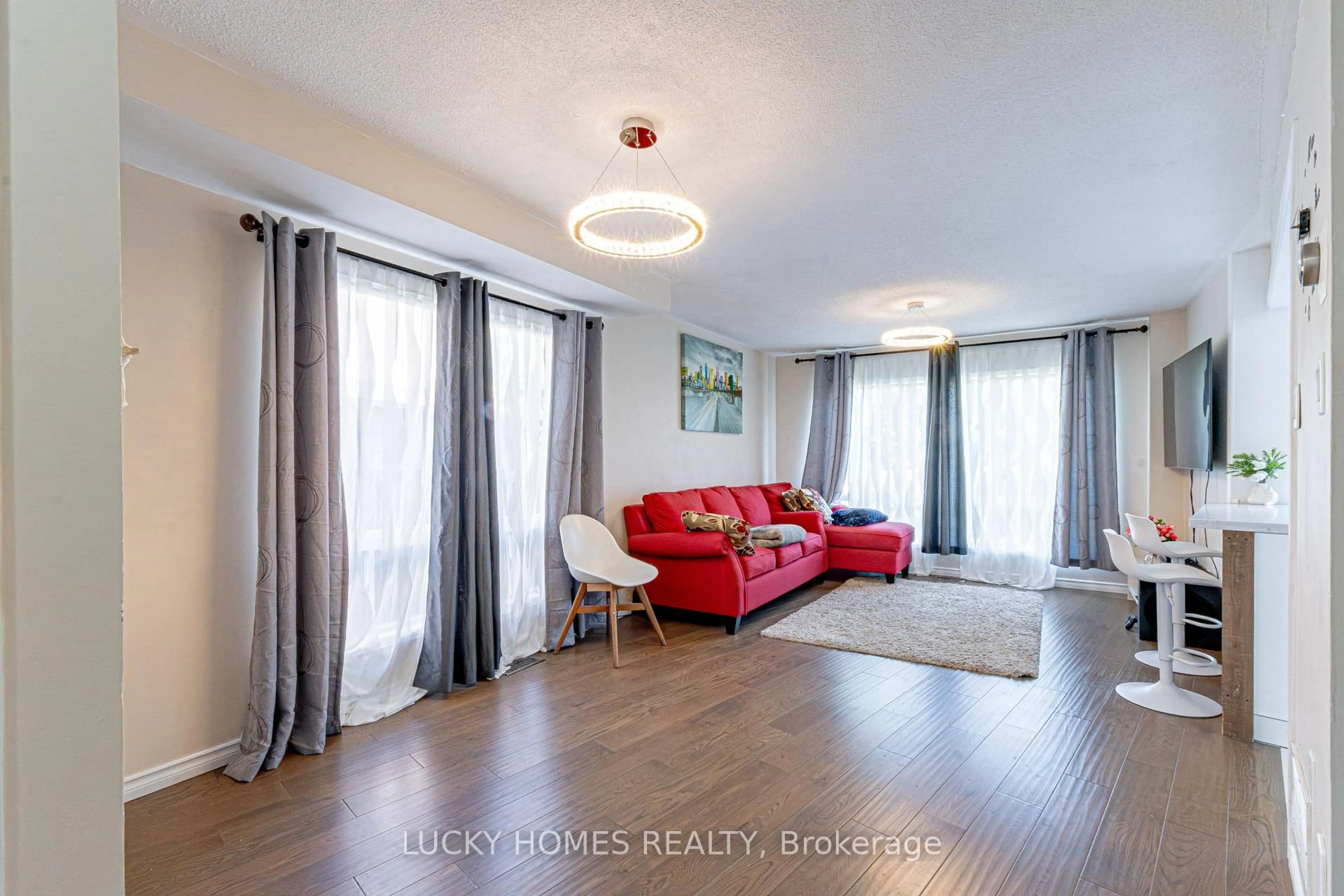 Living room with furniture, wood/laminate floor for 65 Lyfytt Cres, Barrie Ontario L4N 7X5