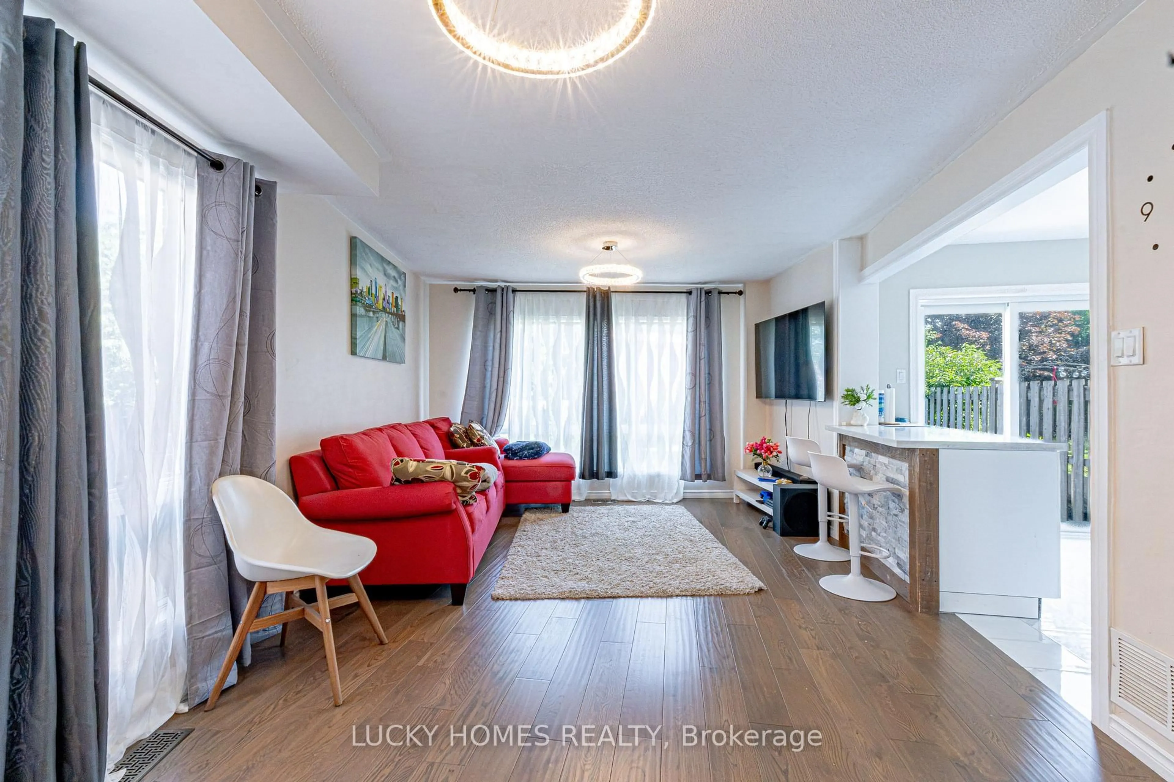 Living room with furniture, wood/laminate floor for 65 Lyfytt Cres, Barrie Ontario L4N 7X5