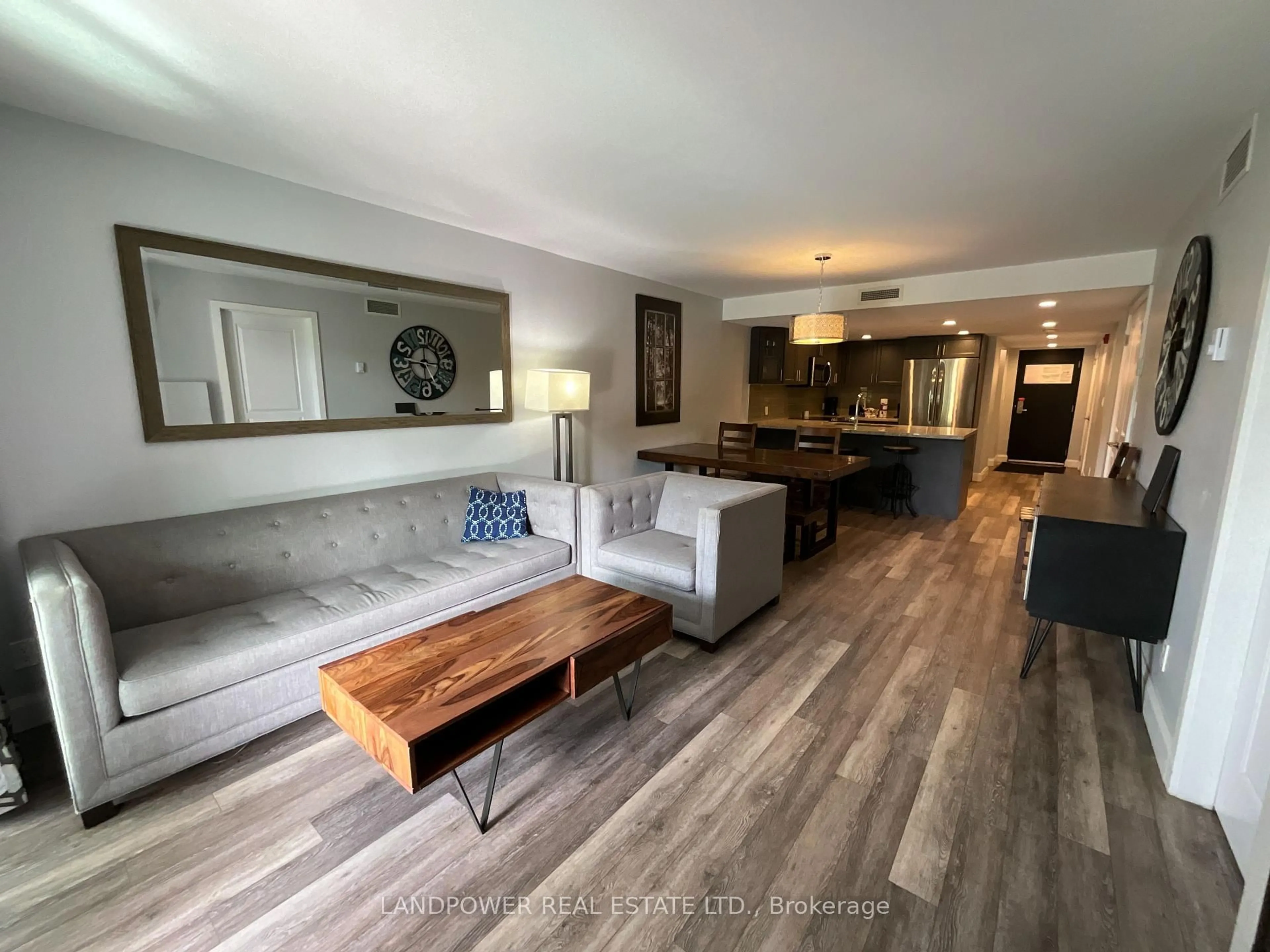 Living room with furniture, wood/laminate floor for 80 Horseshoe Blvd #403, Oro-Medonte Ontario L4M 4Y8