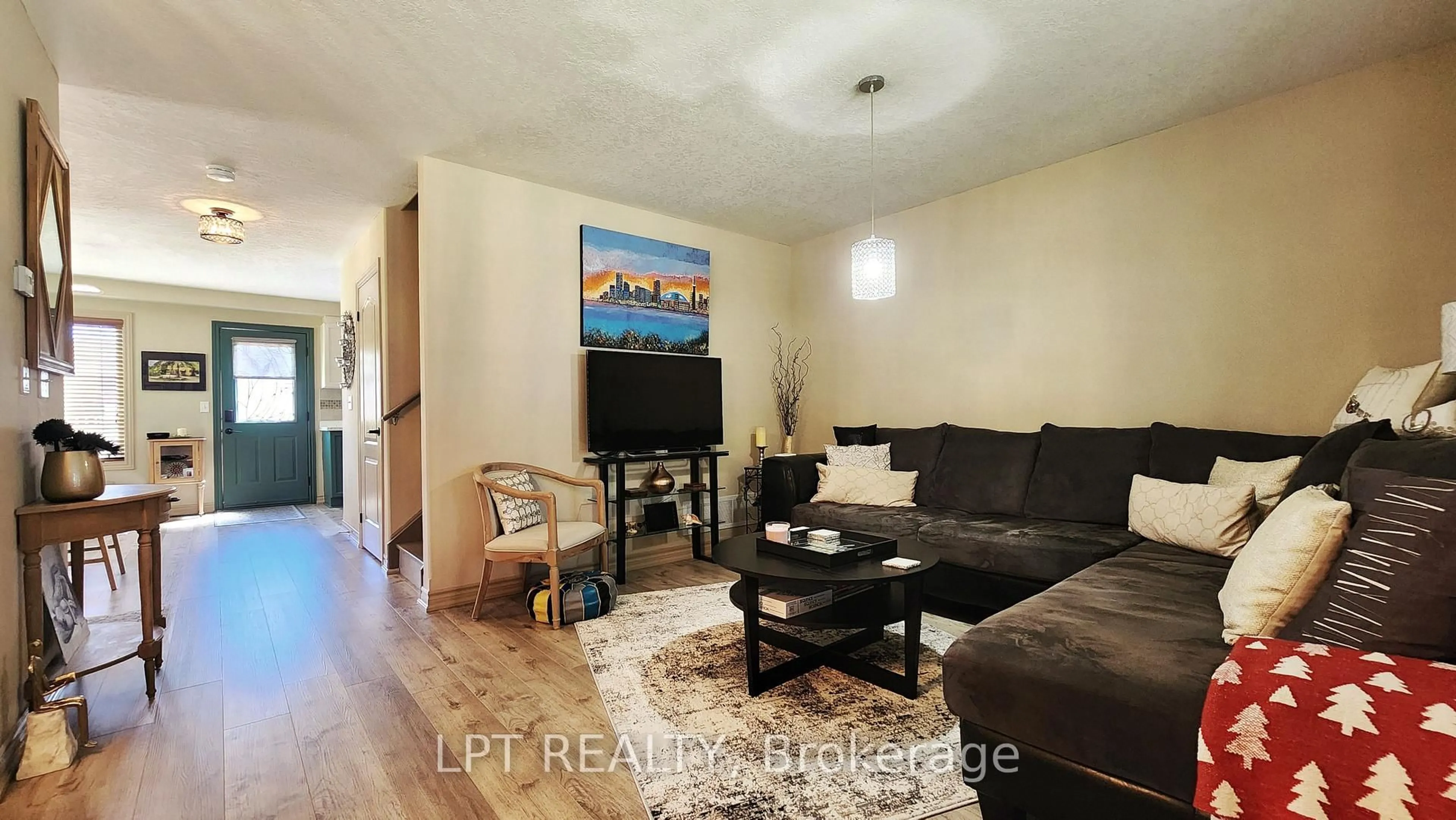 Living room with furniture, wood/laminate floor for 17 Silver Maple Cres, Barrie Ontario L4N 0Y4